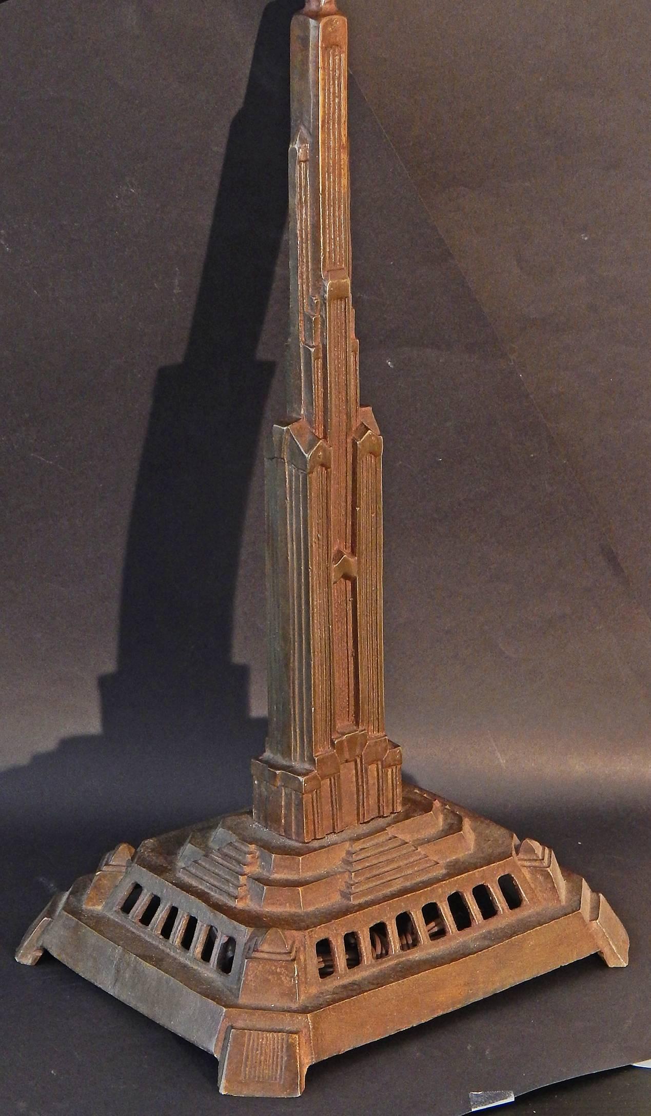 Dramatic, beautifully finished and finely detailed, this very rare pair of bronze lamp bases depict skyscraper buildings, each featuring multiple setbacks in the Classic Art Deco manner, all rising above a multi-staged plinth with cascades of steps