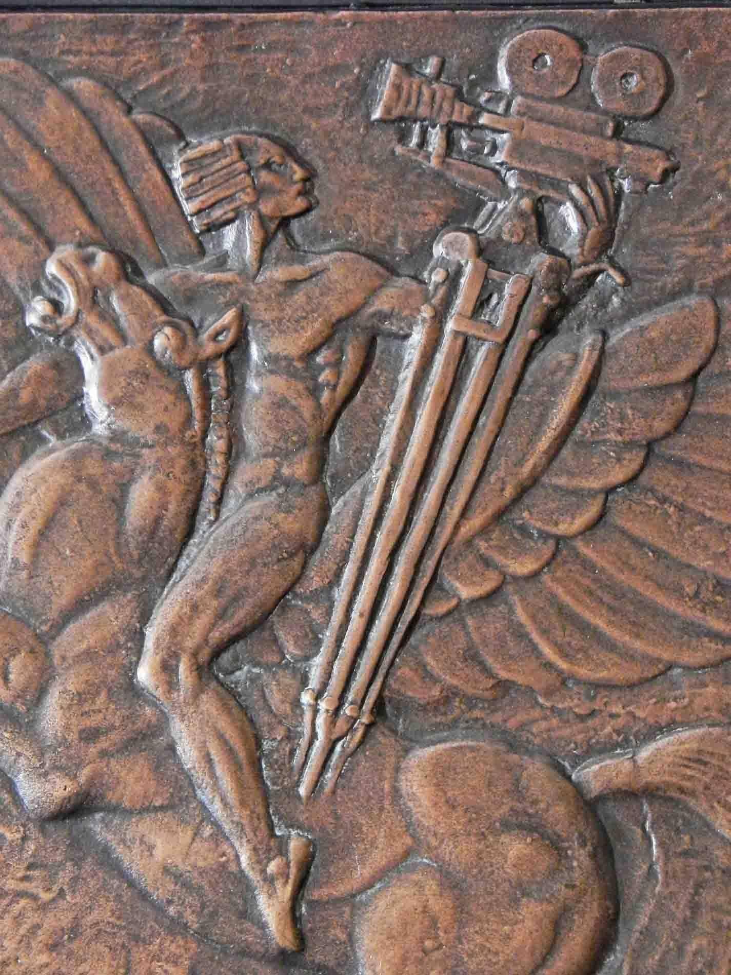 Clearly an allegorical expression of the rise of American cinema, this fabulous and rare bronze panel depicts a nude American Indian figure carrying a modern movie camera, riding Pegasus, the winged horse, with the modern city skyline below. The