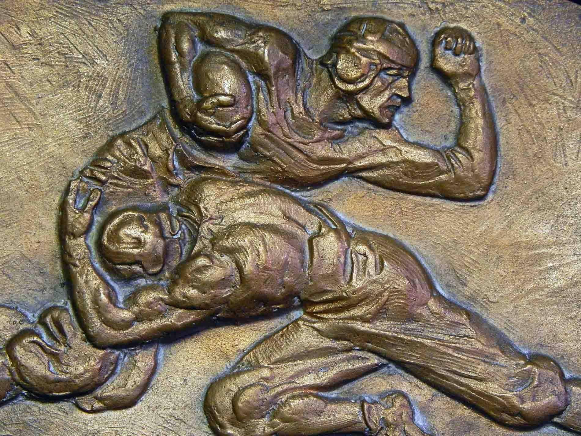 Sculpted and cast as the prototype for a bronze awards plaque celebrating accomplishment in American football, this piece shows two players in the middle of a dramatic tackle. The artist, Fred Torrey, is best known for his 