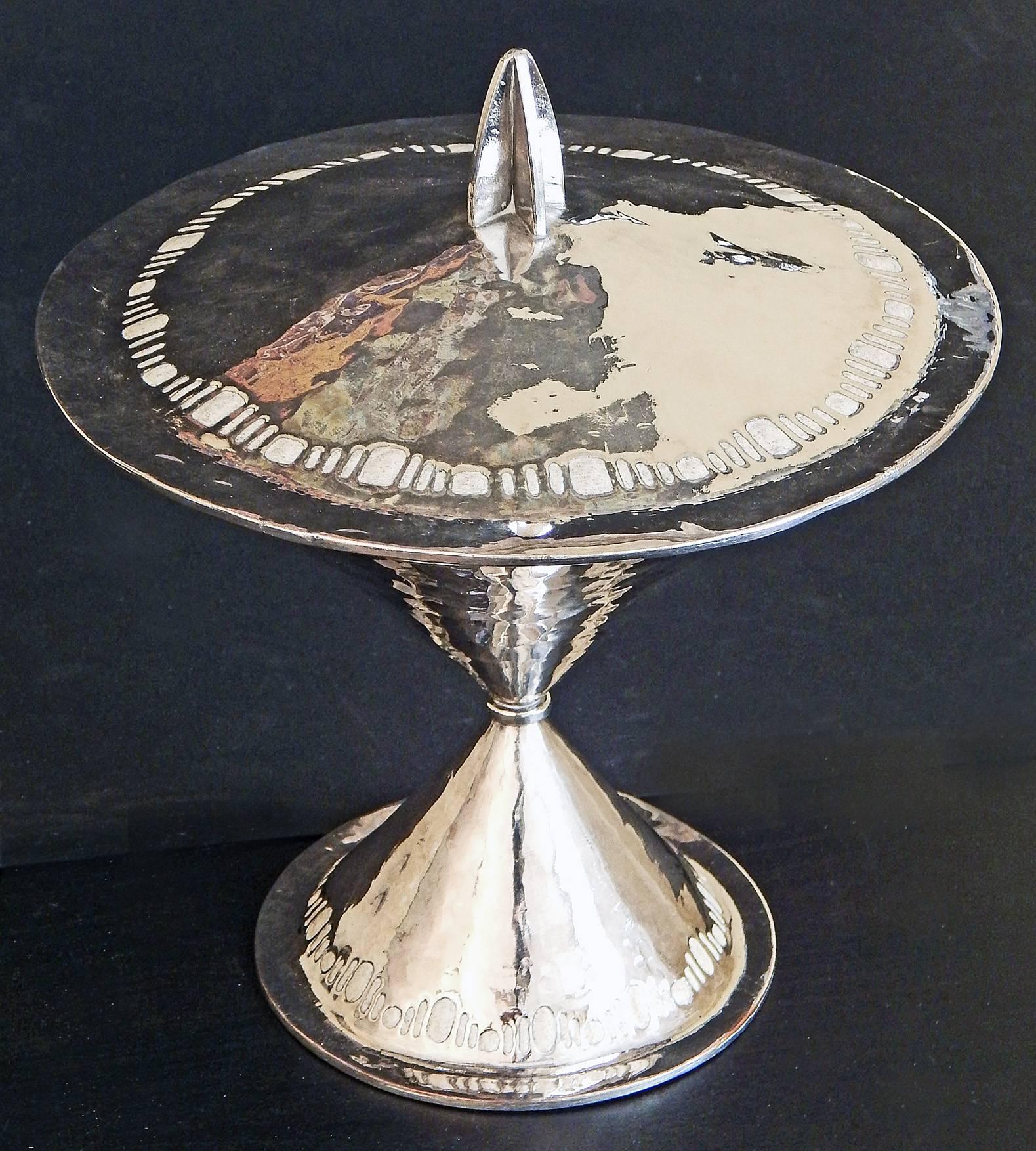 One of the most astonishing early Art Deco silver pieces we have seen, this large silver and enamel lidded compote was smithed in 1922 by Pierre Carrel. The French were among the first to design stylized Classical pieces that later became known as