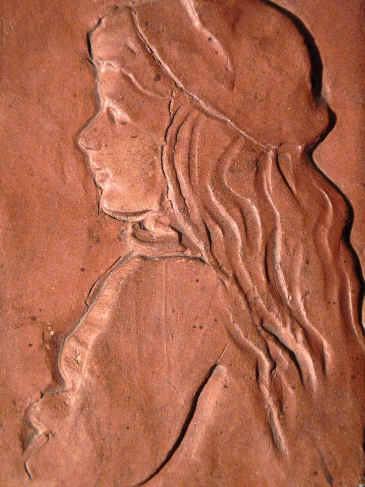 Charming and winning, this unique terracotta plaque, sculpted and fired by Bela Janowsky, depicts a lovely girl with long hair and a beret. Janowsky is known for his large bas relief sculpture, 