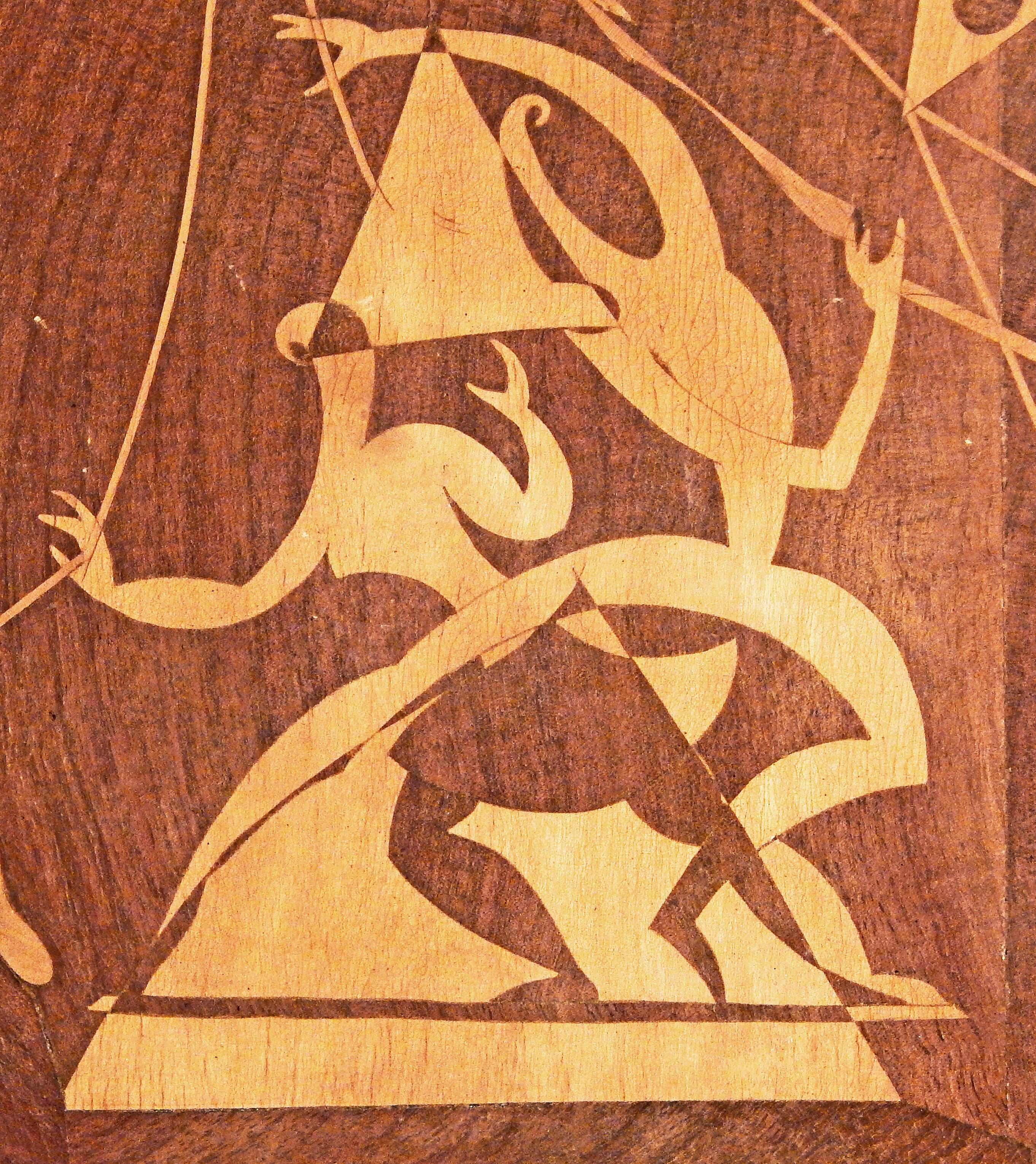 Brilliantly designed and executed, this example of wood inlay Folk Art, by Renato Maggiora in 1953, depicts a pair of circus acrobats at the centre, highly stylized and showing the influence of Cubism, Surrealism and midcentury abstraction. To the