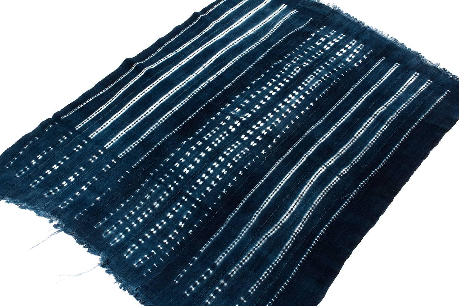 This vintage textile is woven from hand-spun African cotton and dyed with Indigo. The patten is a Indigo dye resist technique. Very soft Cotton and Luminous dye.
