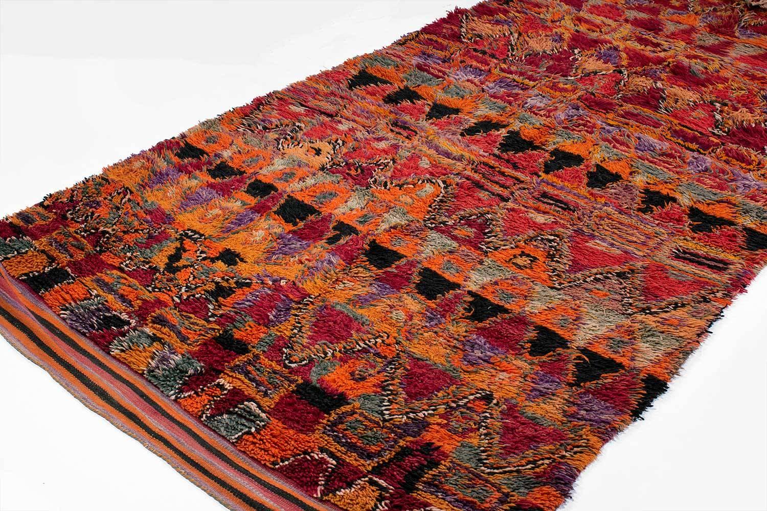 A beautiful vintage Berber rug from Morocco, probably woven in the 1970s and in excellent condition. This rug had thick, lustrous wool pile and exceptional colors. Holds wonderful color variations and irregular geometric. 
