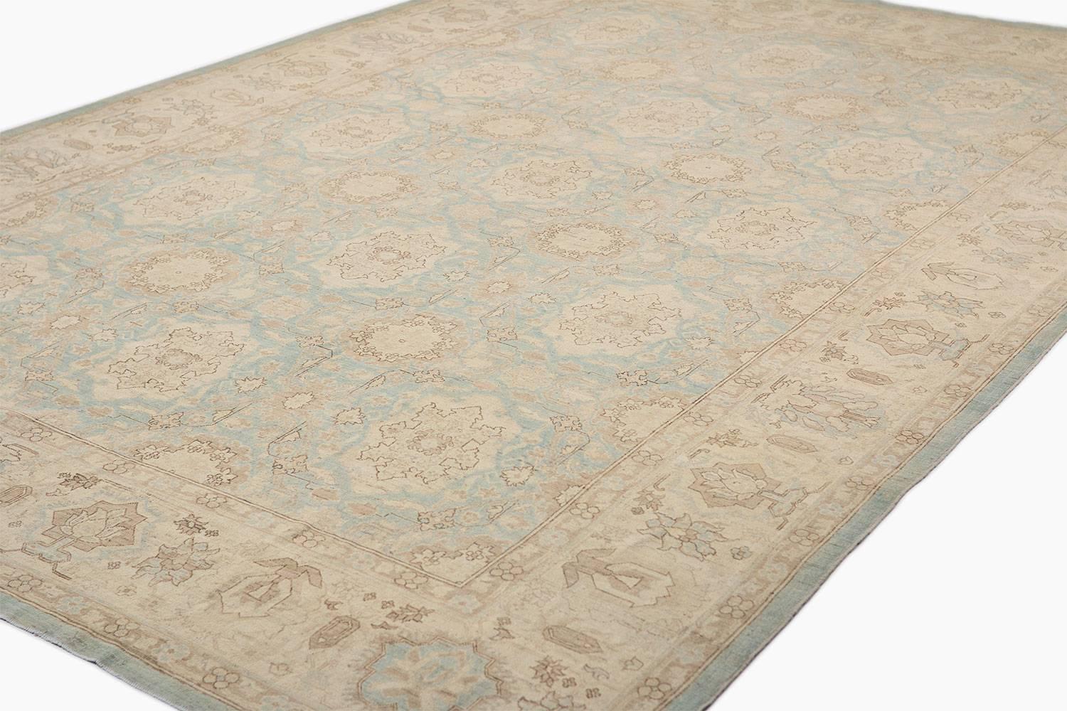 This carpet is handwoven and artfully sheared down to create a dreamy pastel art rug. Measures: 9'8" x 13'10.

It's muted cream and light blue carpet has a traditional style and geometric and floral motif. Handwoven in Afghanistan, cotton