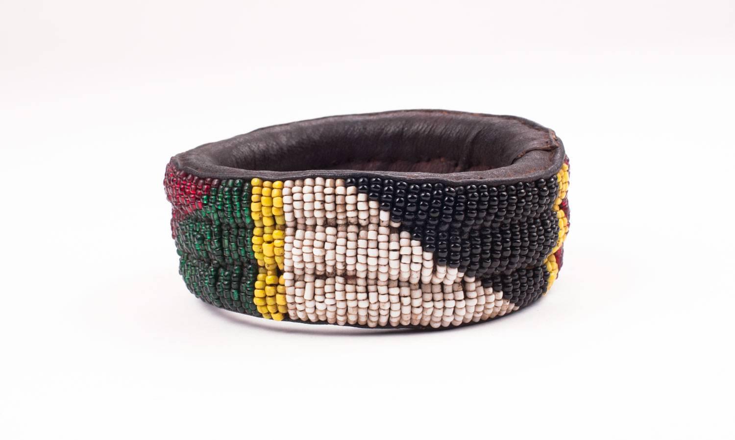 An African Yoruba tribal  bracelet made of hand stitched leather and hand sewn beadwork.Dating from the 1980's  these older bracelets are of much better quality then later ones. The beads are very carefully sewn on and the piece is strong.