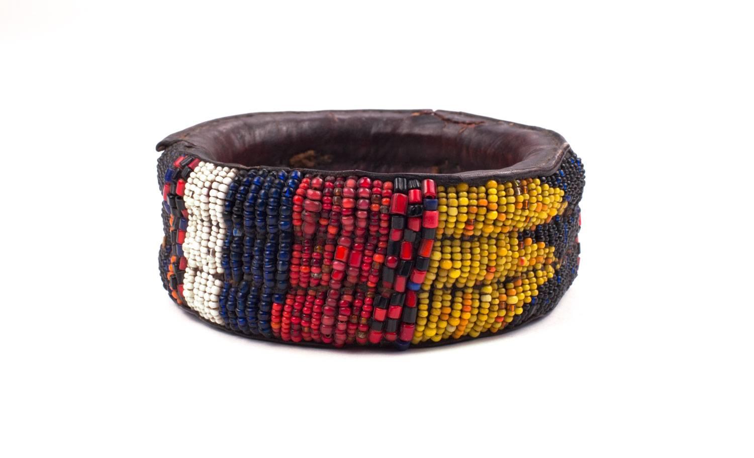 An African Yoruba tribal bracelet made of hand-stitched leather and hand-sewn beadwork. Dating from the 1980s these older bracelets are of much better quality then later ones. The beads are very carefully sewn on and the piece is strong. These old