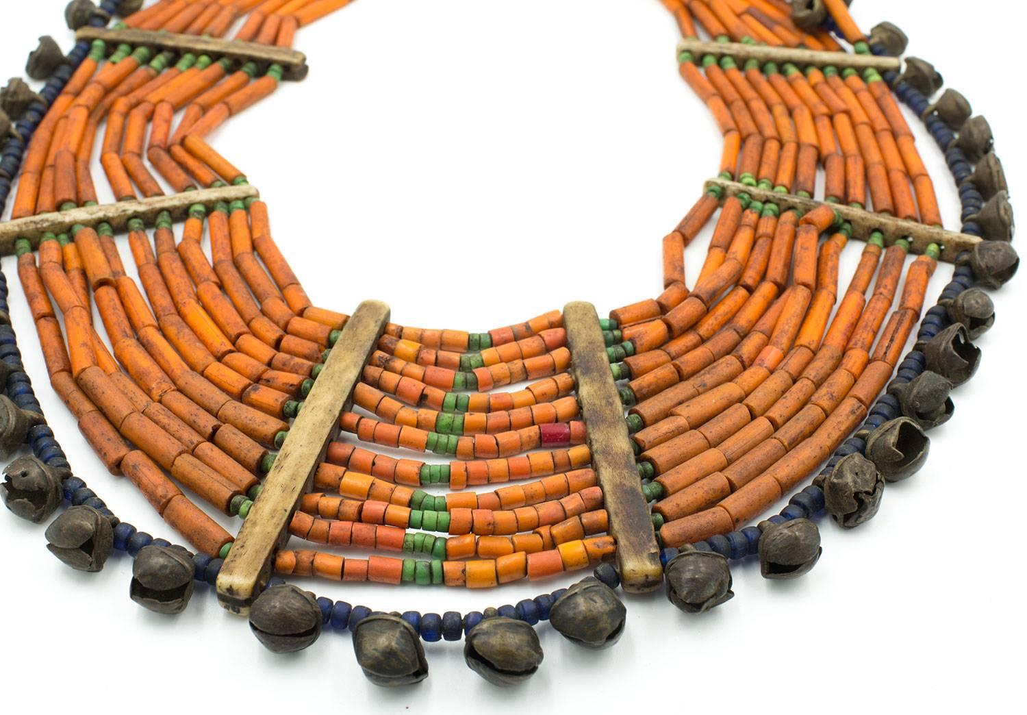 A very old woman's necklace from Nagaland. Real Naga pieces are rare- this is one of them. Made with fantastic old bronze bells, orange glass beads, old cobalt beads, turquoise beads and bone spacers. Finished off with an old coins it's clasp.
The