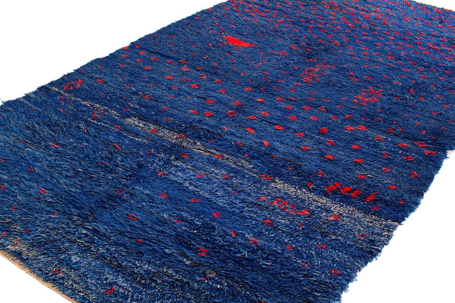 This piece is highly unusual and rare. This vintage Moroccan rug shows a chicken motif and red dots throughout. There is spectacular indigo color with slight abrash across the field. This piece is truly one-of-a-kind!