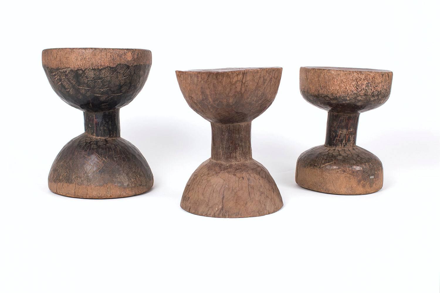 This set of drum stools are from Ethiopia, circa early 20th century and made from dense wood with natural patina and good age. These drum stools have old inventory numbers on them from a previous collection. These were initially made for stools but