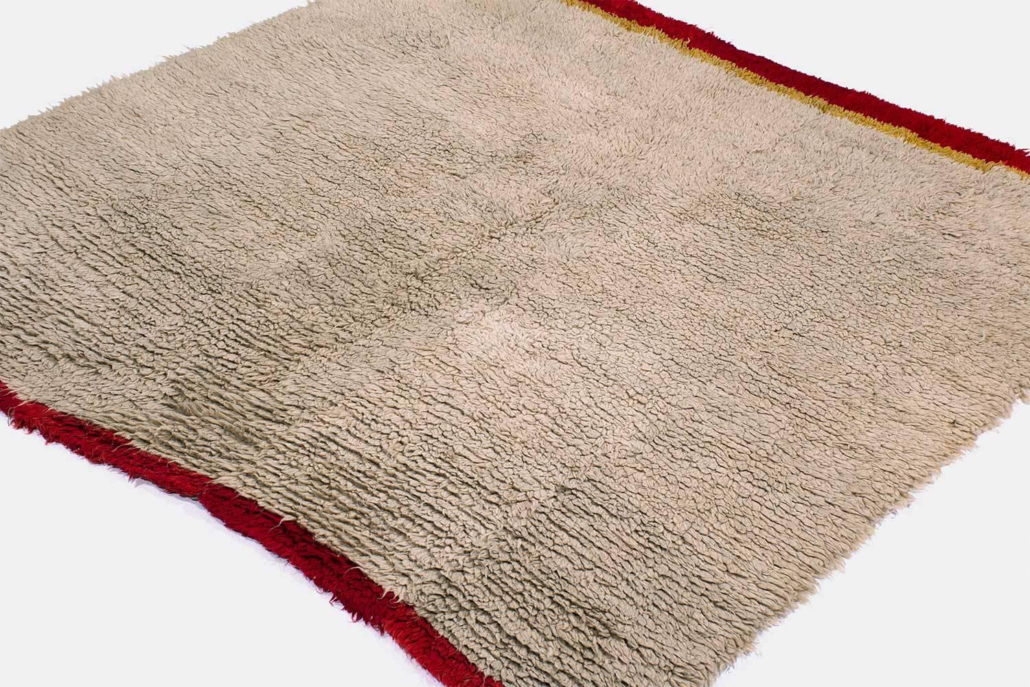 This rug can serve as either a rug or a blanket. Woven by nomads high up on the Tibetan Plateau, it was used as a blanket and a rug to be slept on. The rug is very soft and floppy like a textile. It was woven on a hand loom in small strips and