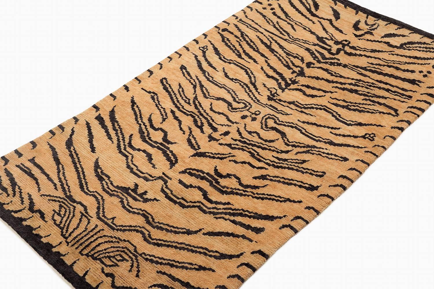 'Sanskrit Tiger' carpet is a fresh take on an original Joseph Carini design. It has a textured weave - a Devi weave, 60 Knot. It is 100 % wool, hand-spun, and handwoven in Nepal. The abstract animal print is bold but not overwhelmingly