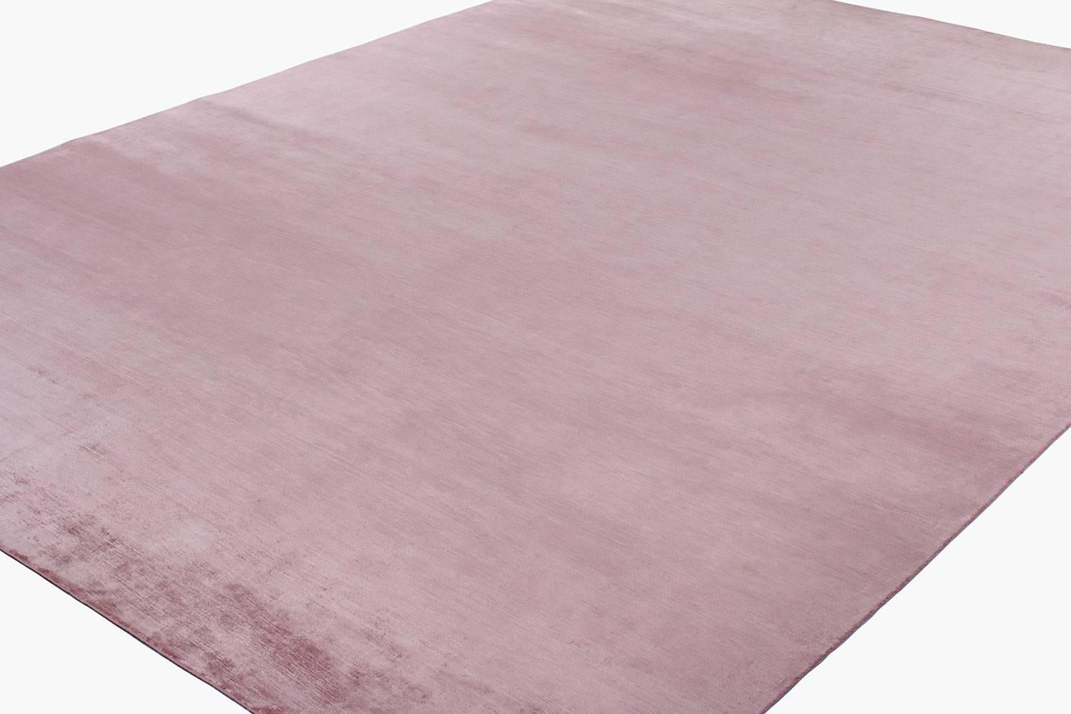 This solid silk carpet is stunningly simple. The powder pink tone was achieved with 100% natural botanical dyes. Featured in the top left corner is a delicate hummingbird, this tiny accent is enchanting. Weaved in a 200 knot count, the pile height