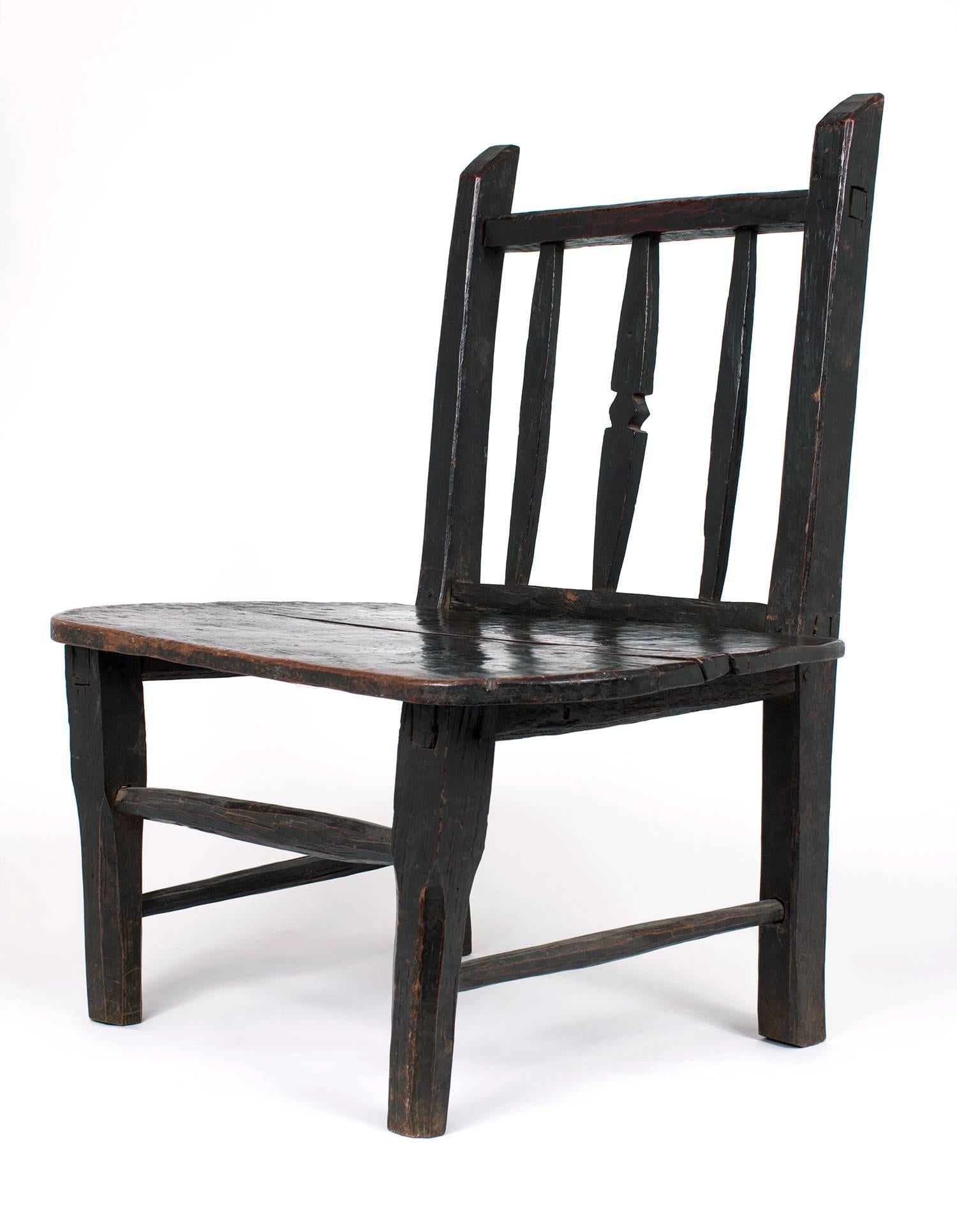 Elegant and sturdy dark wood tribal chair. Vintage, in excellent condition from the West Coast of Africa.
