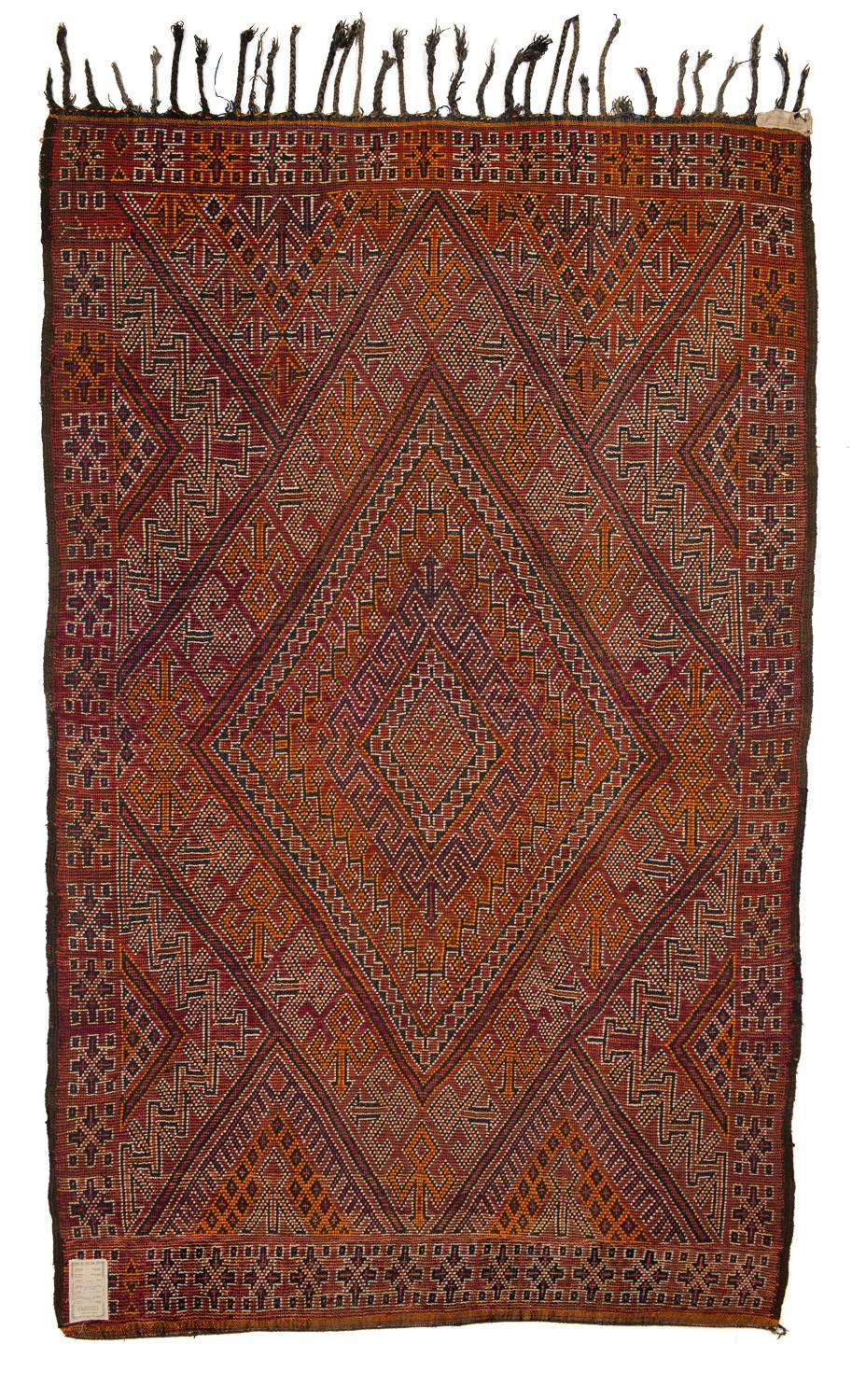 This vintage Beni Mguild Moroccan rug is pure energy and fire- like an Italian sport car. It has lost of old deep indigo that proves that the piece is pre-1950. Hard to find these with this quality of color. It represents the best of Primitive