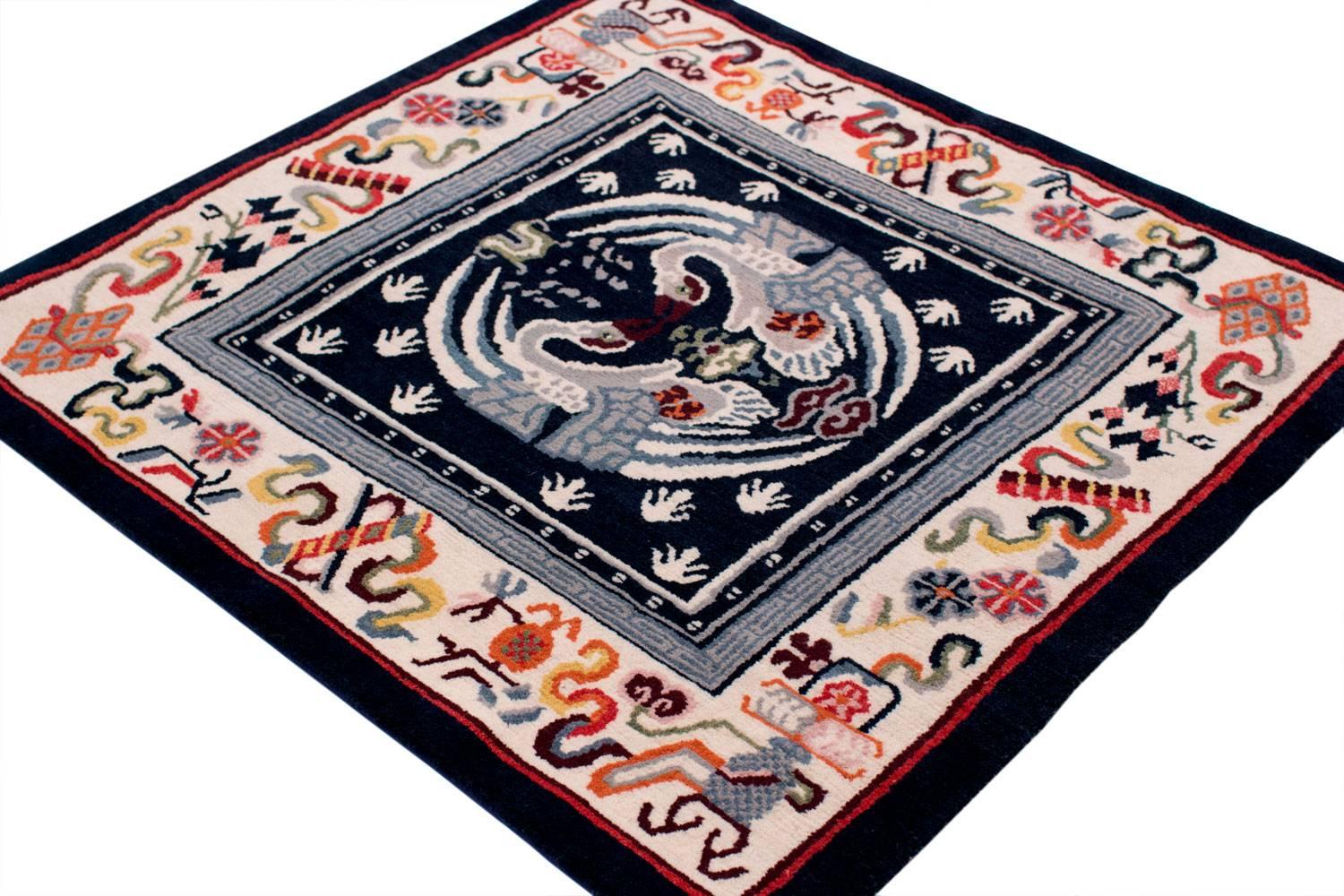 This spectacular reproduction of a small antique Tibetan mat was made with 100% vegetable dyes made using authentic Tibetan weaving techniques. 100% Himalayan wool. In beautiful blue color scheme with multicolored border.
