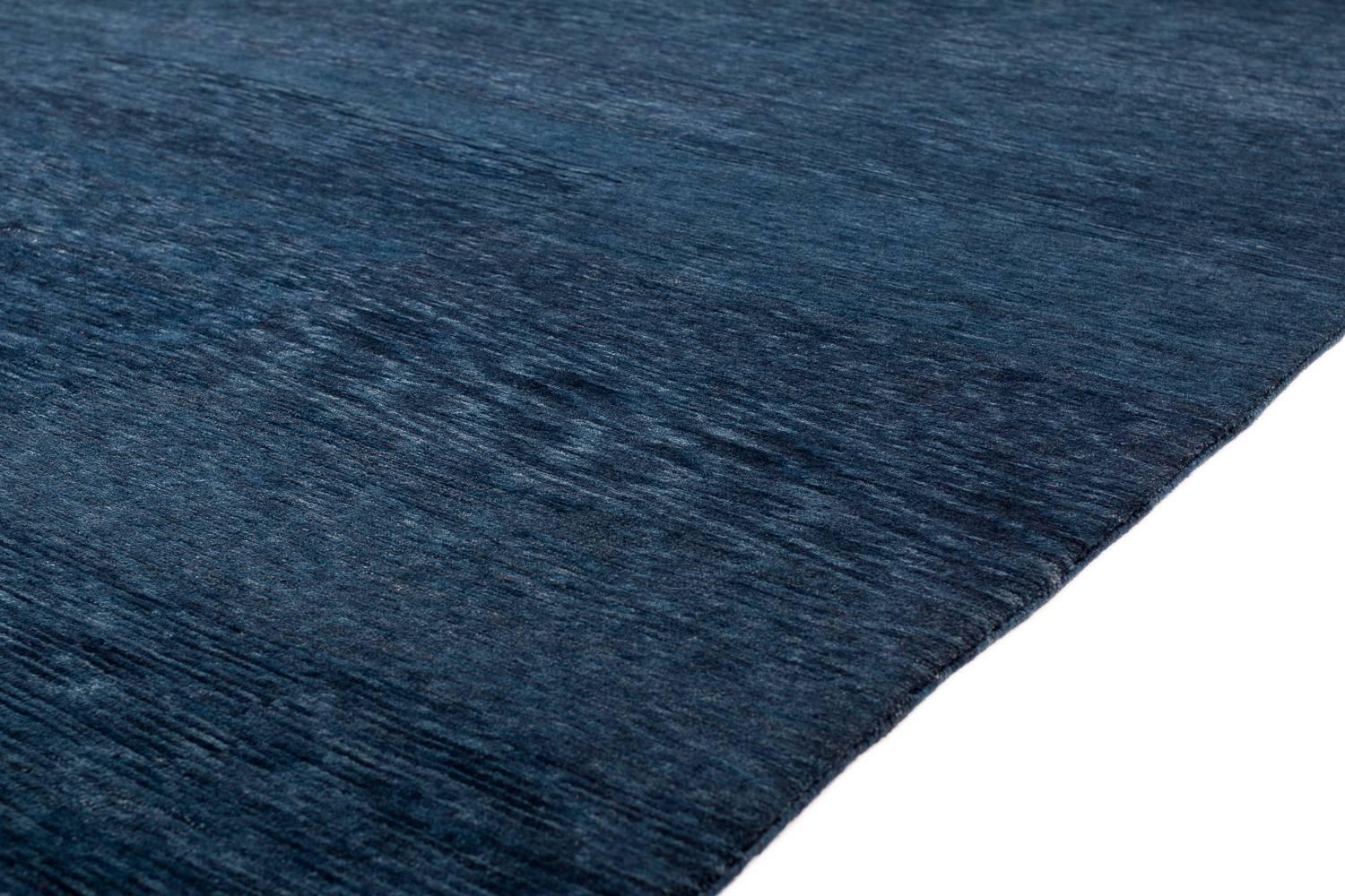 This hypnotic hand dyed indigo carpet was made using hand spun Himalayan wool of the finest quality. The high lanolin content in the wool naturally repels liquid making it extremely resilient to stains. This carpet has a stunning abrash throughout.
