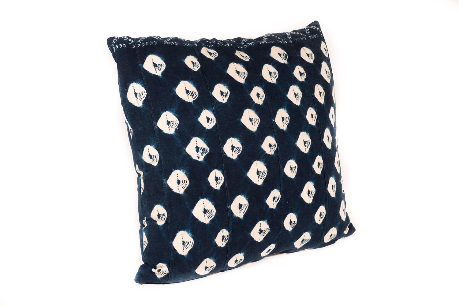 This large pillow is made from a vintage African textile. The polka-dot pattern is formed using complex tie-dye techniques with natural indigo. The best part is the soft and raw organic cotton which has backed for durability. The cushion content is