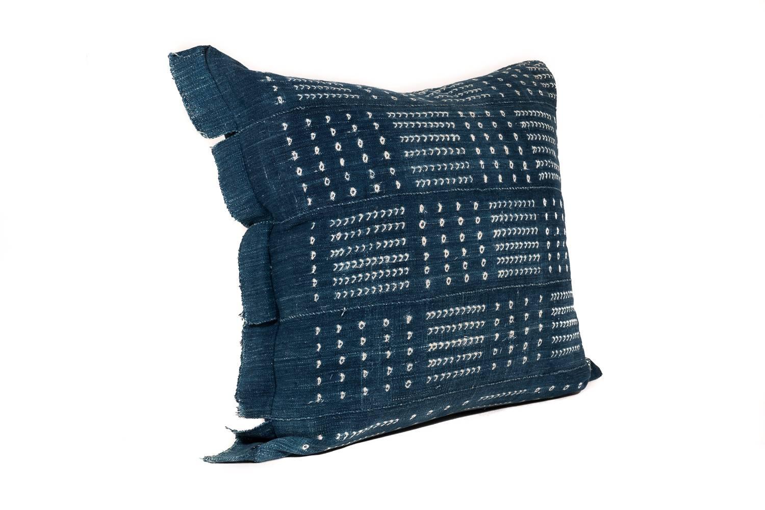 This large pillow is made from a vintage African textile. The polka-dot pattern is formed using complex tie-dye techniques with natural indigo. The best part is the soft and raw organic cotton which has backed for durability. The cushion content is