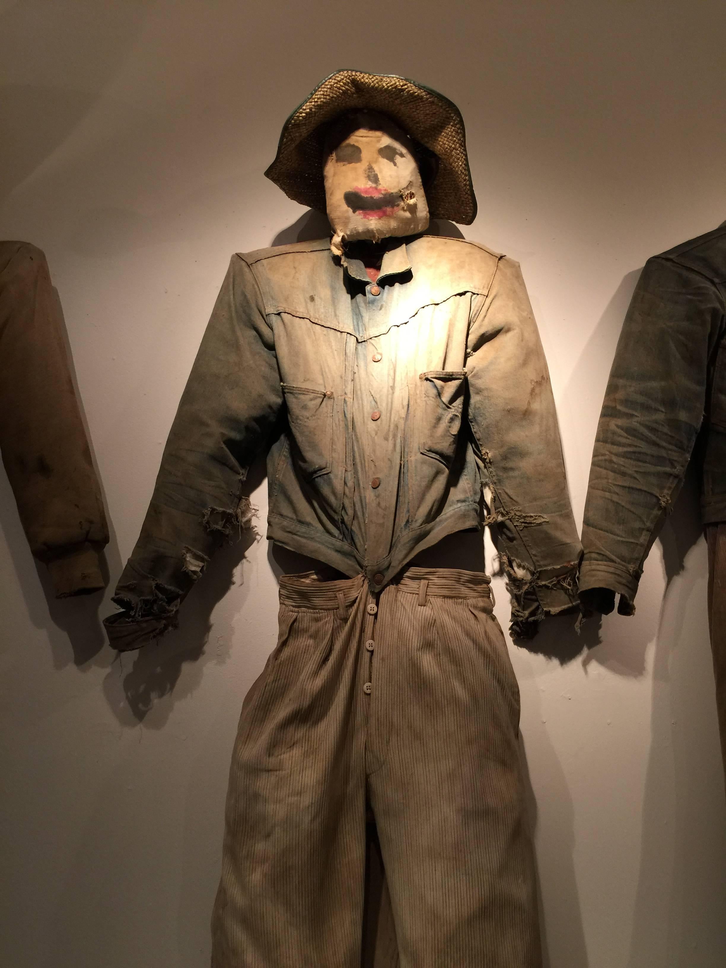 This vintage scarecrow came out of a barn in Vermont. I'm not sure of the age but the clothing suggests the 1940s. He's been restuffed with plastic sheeting at some point in his life.