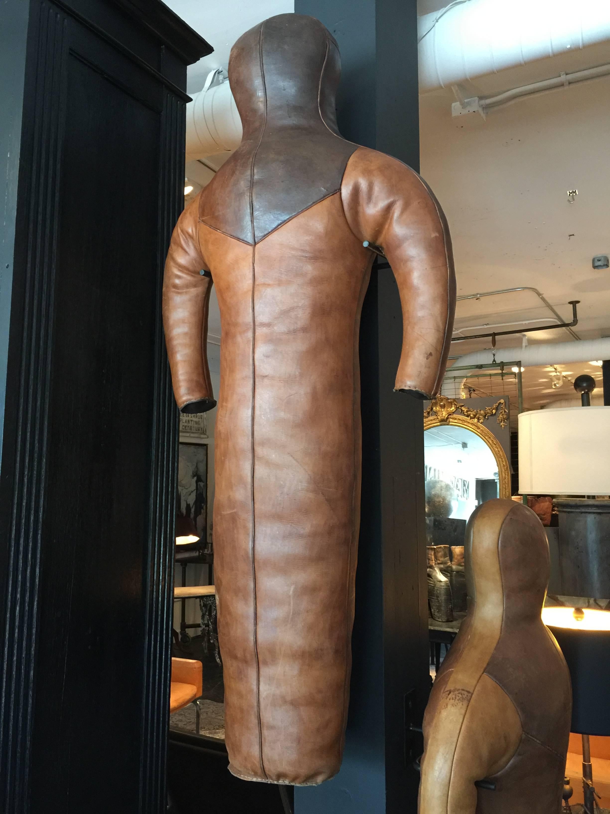 1930s German leather wrestling dummy on a custom-made steel wall-mounted stand. There are two of these available. Both dummies come with the steel wall mount, but each dummy is a little different. One has some writing on the left side and the other