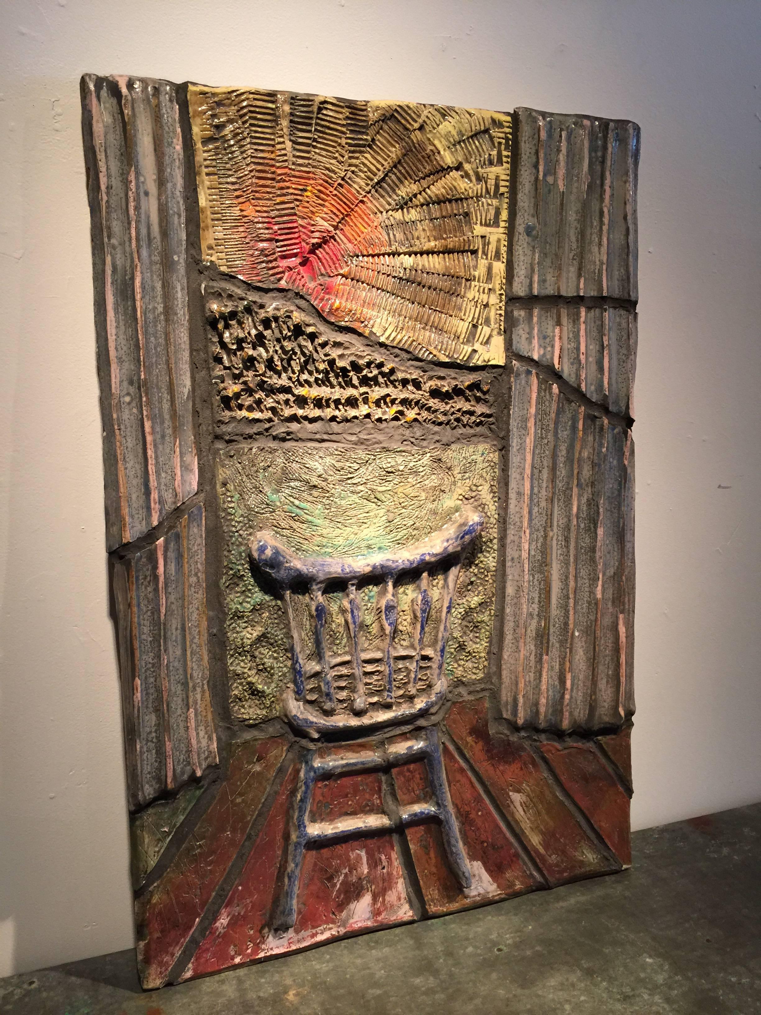 Ceramic wall art depicting a chair facing sunset flanked by two architectural columns. This piece weighs approximately 40lbs so a custom French cleat is mounted to the back for easy installation.