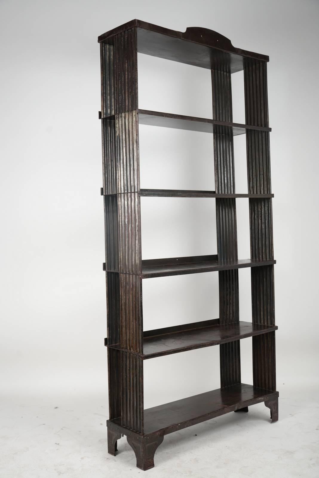 Stamped steel Art Deco four-shelf display unit.