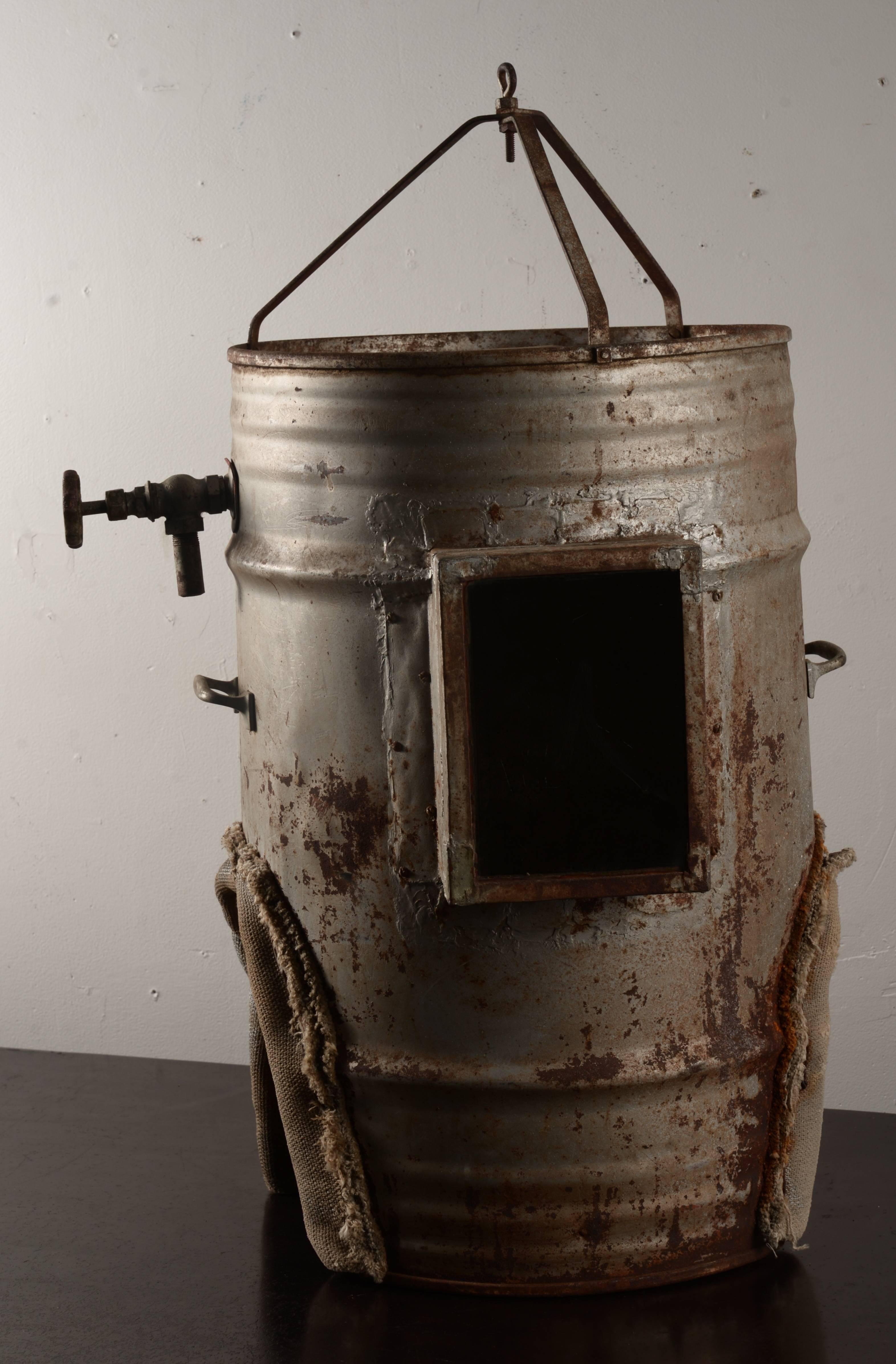 Handmade shallow diving helmet created out of a vintage galvanized drum with canvas padded shoulder cut-out.