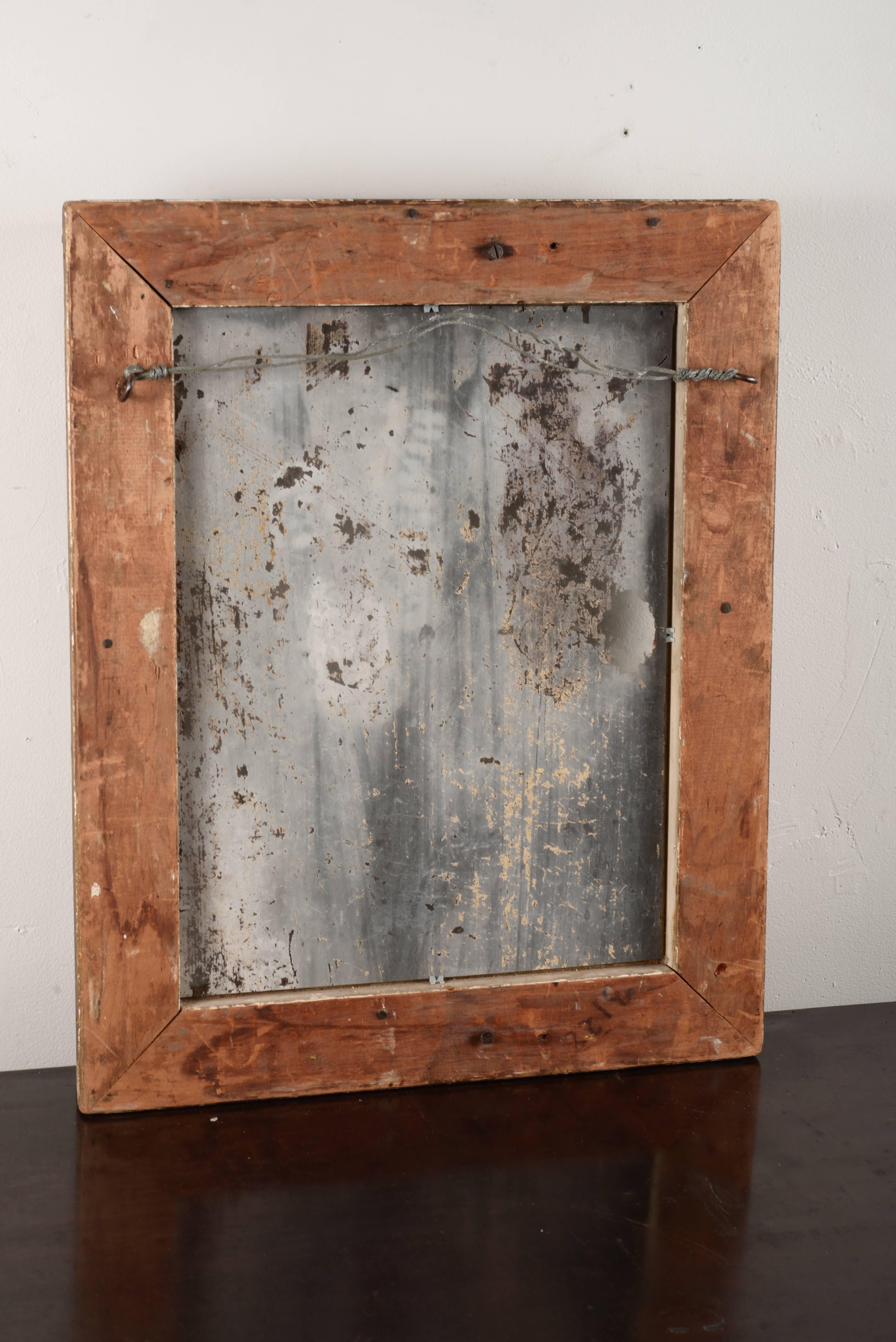 Ornate distressed gold framed mirror with original glass.