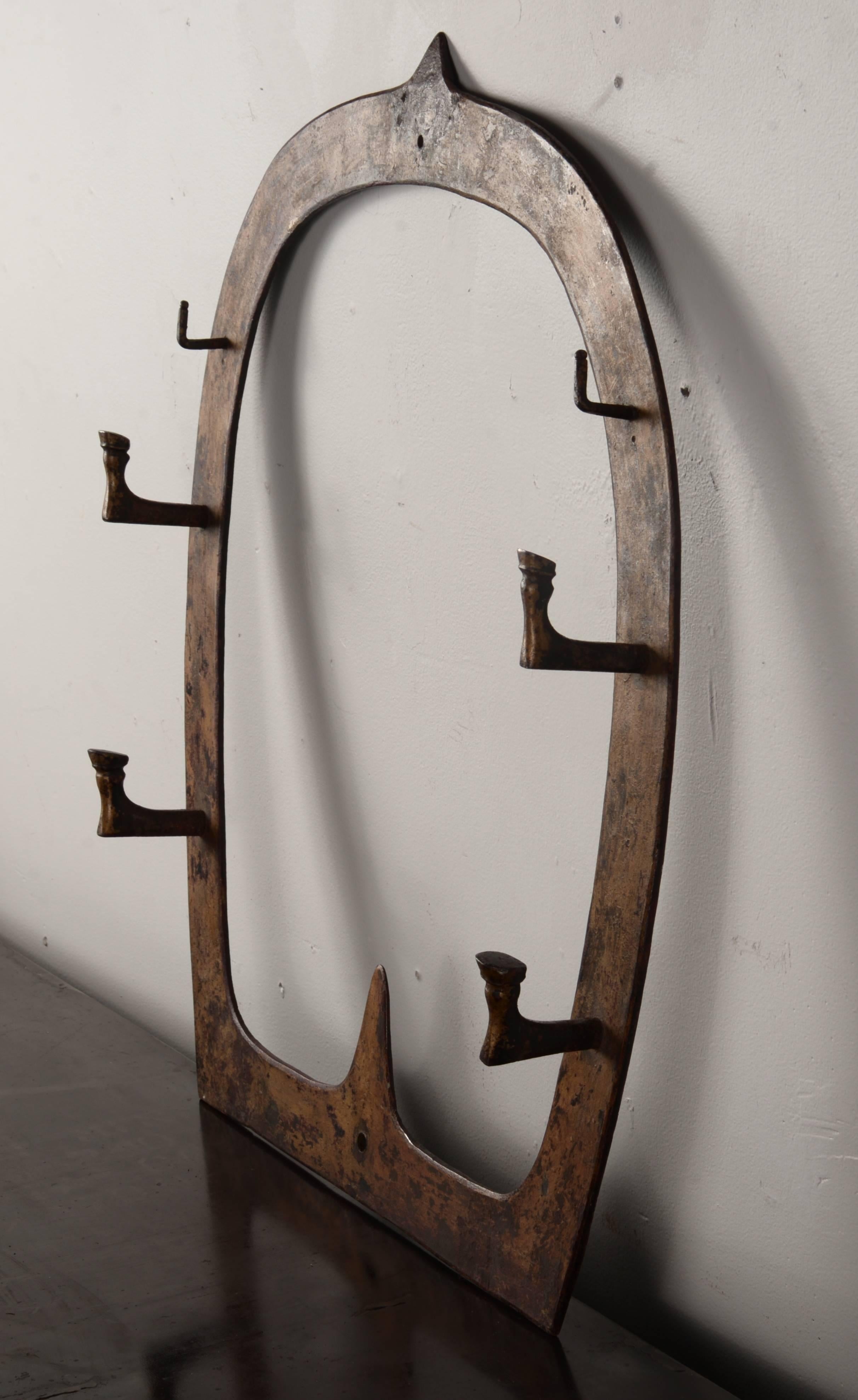 Steel horse shoe coat or hat rack with distressed gold over paint.