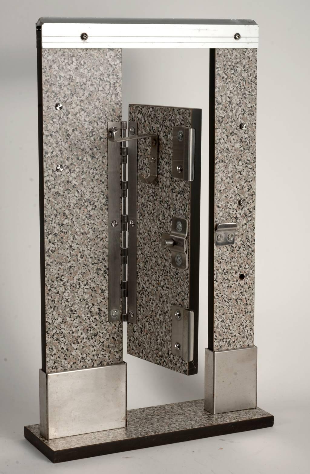 Single door toilet stall salesman's sample constructed out of formica with steel and aluminum detailing.