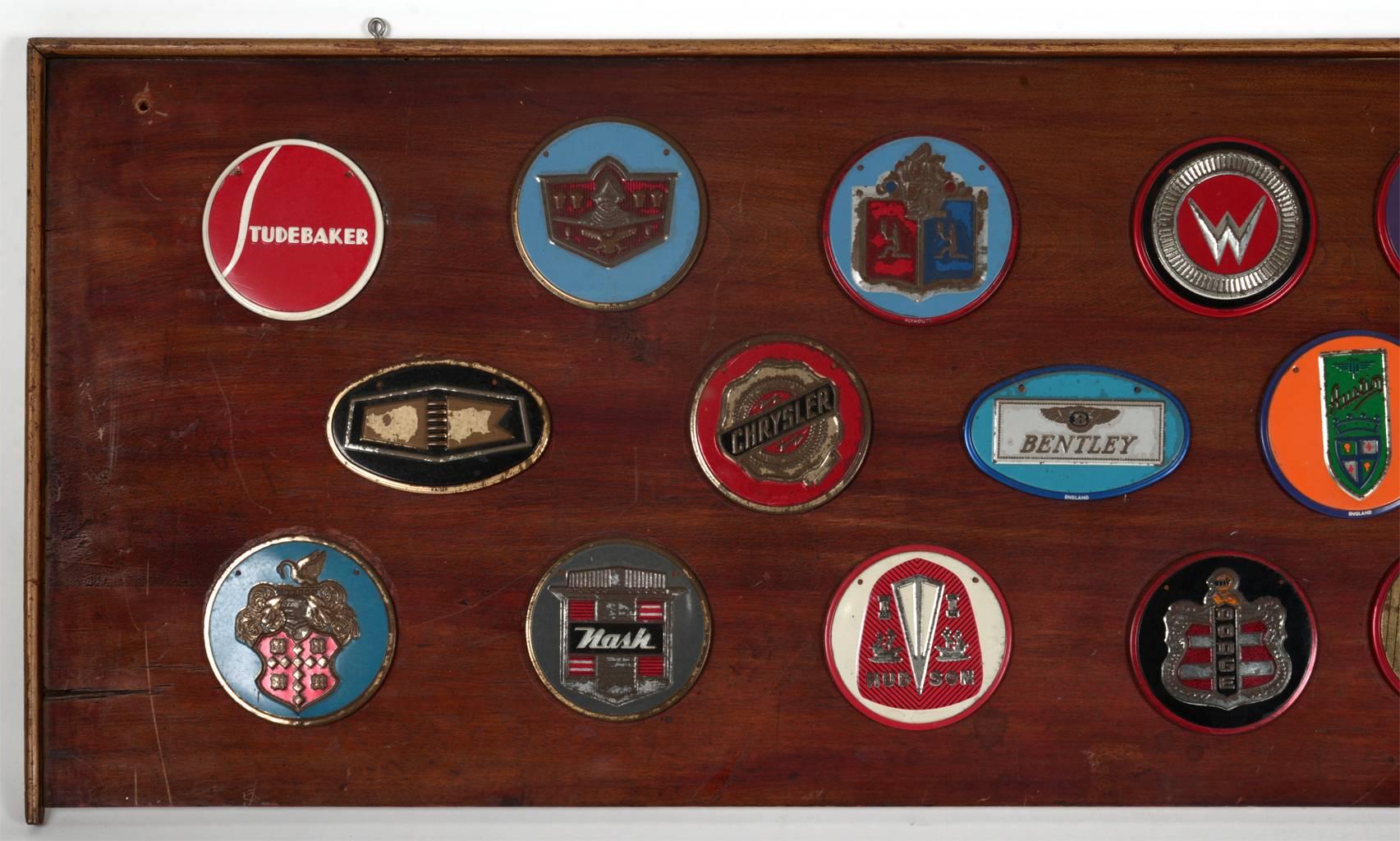 Auto nameplate collage. Collection of 31 elite auto logos on a wooden panel.