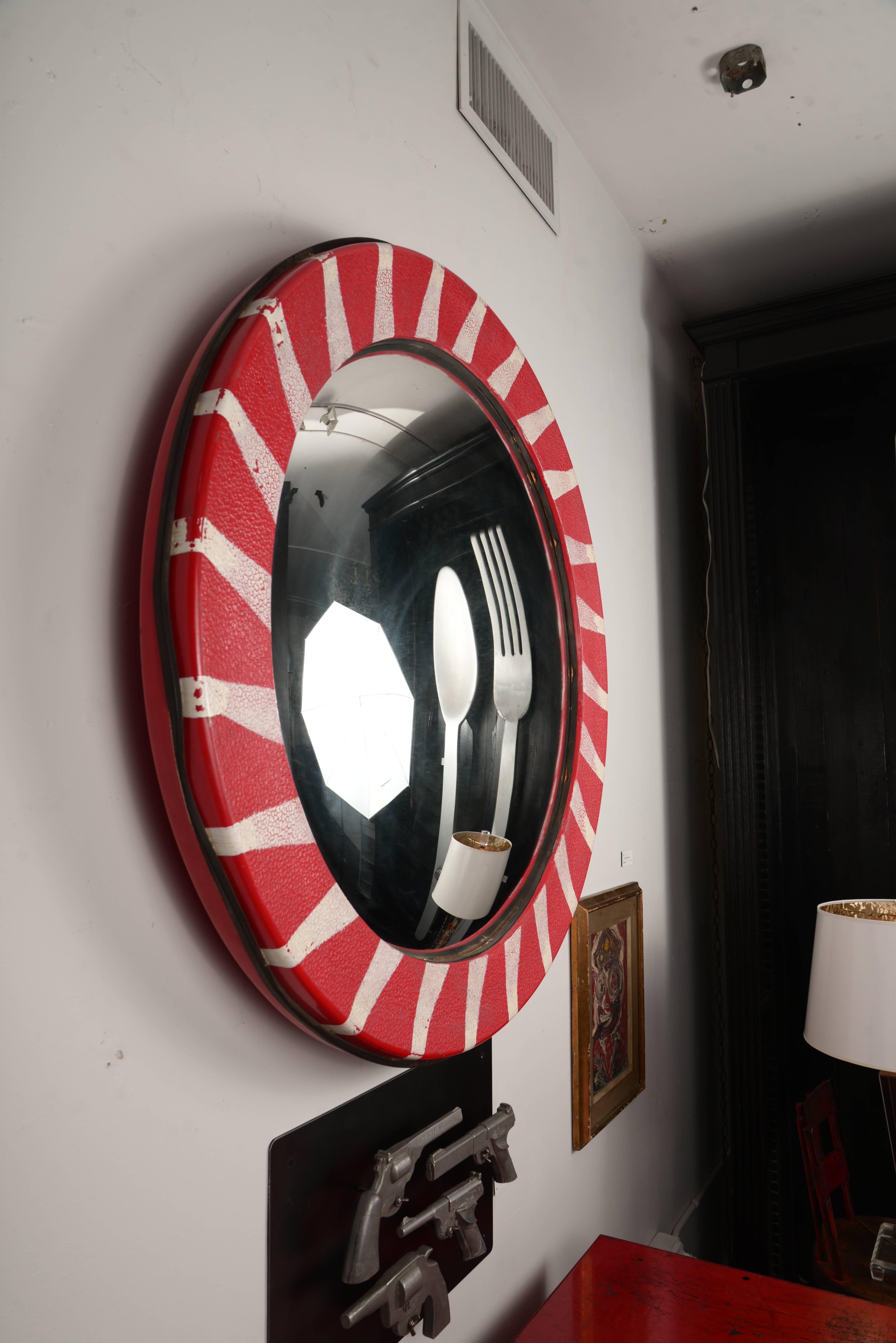 Large round convex mirror framed in graphic painted textured plastic. We've added a custom-made bracket that allows this to 