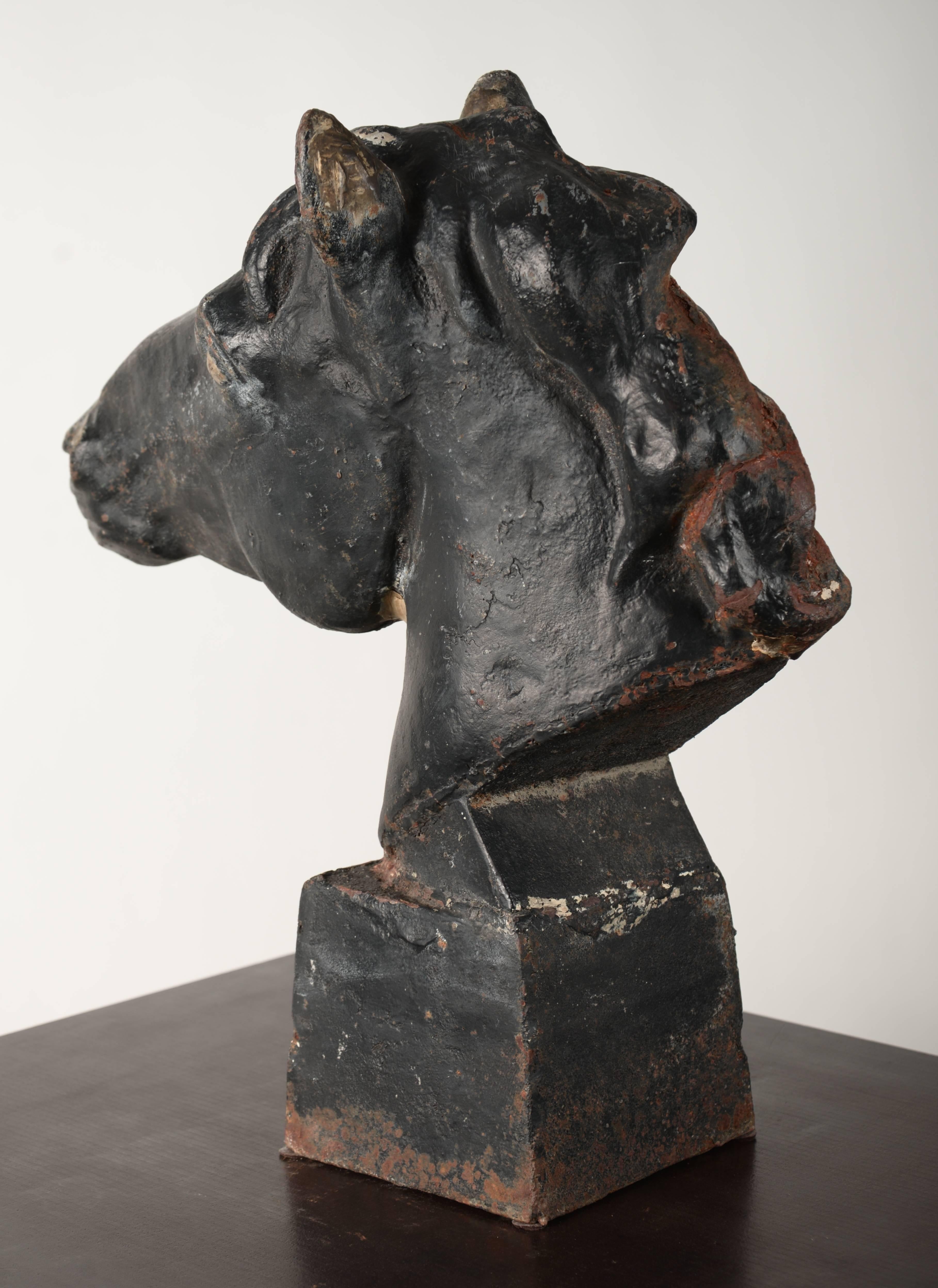 Cast iron horse head with black overpaint. I believe this originally served as a fence post top.