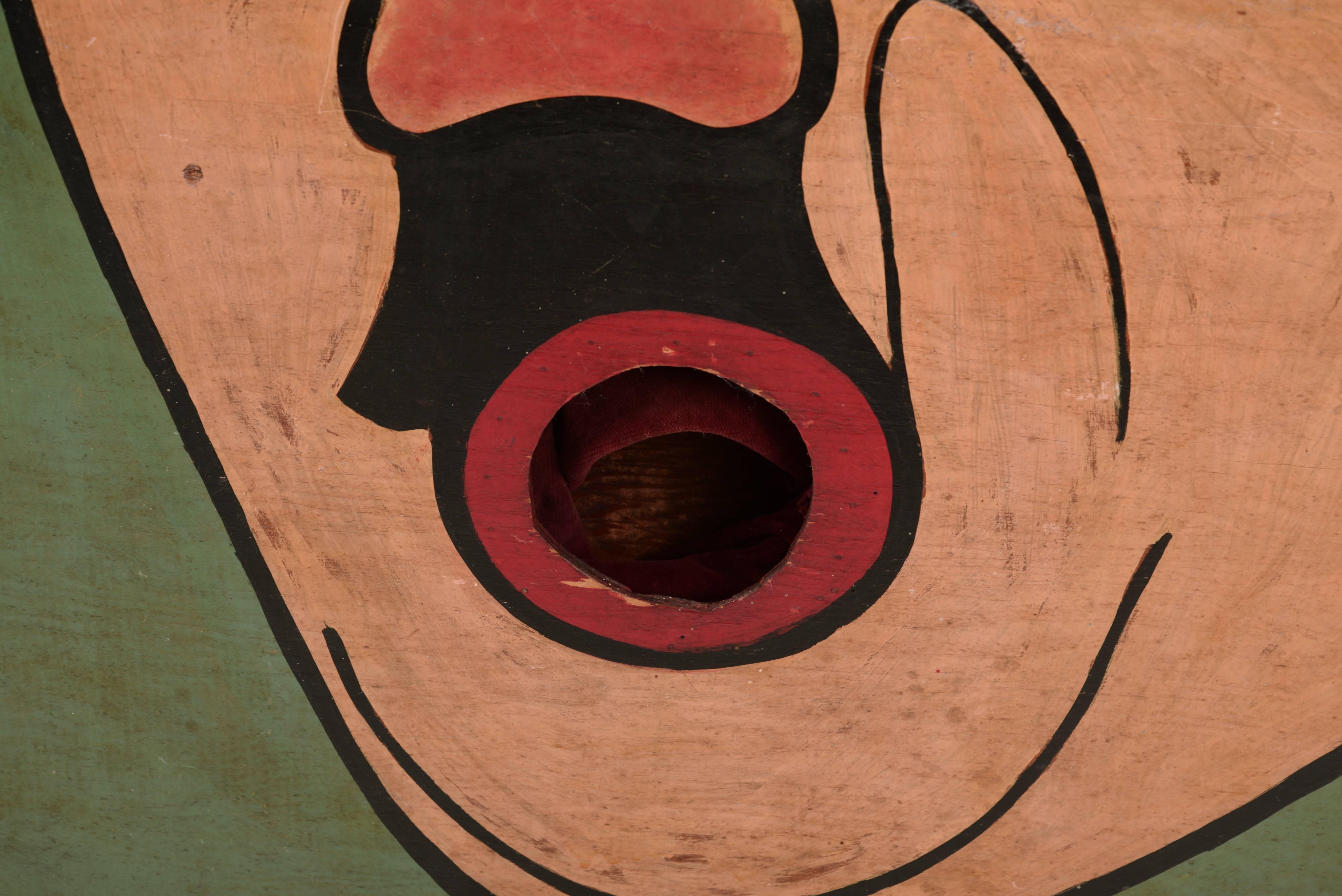 Hand-painted wooden panel depicting a caricature of Adolf Hitler. The exaggerated round mouth area served as the target with an expandable velvet panel in the back to catch successful tosses.