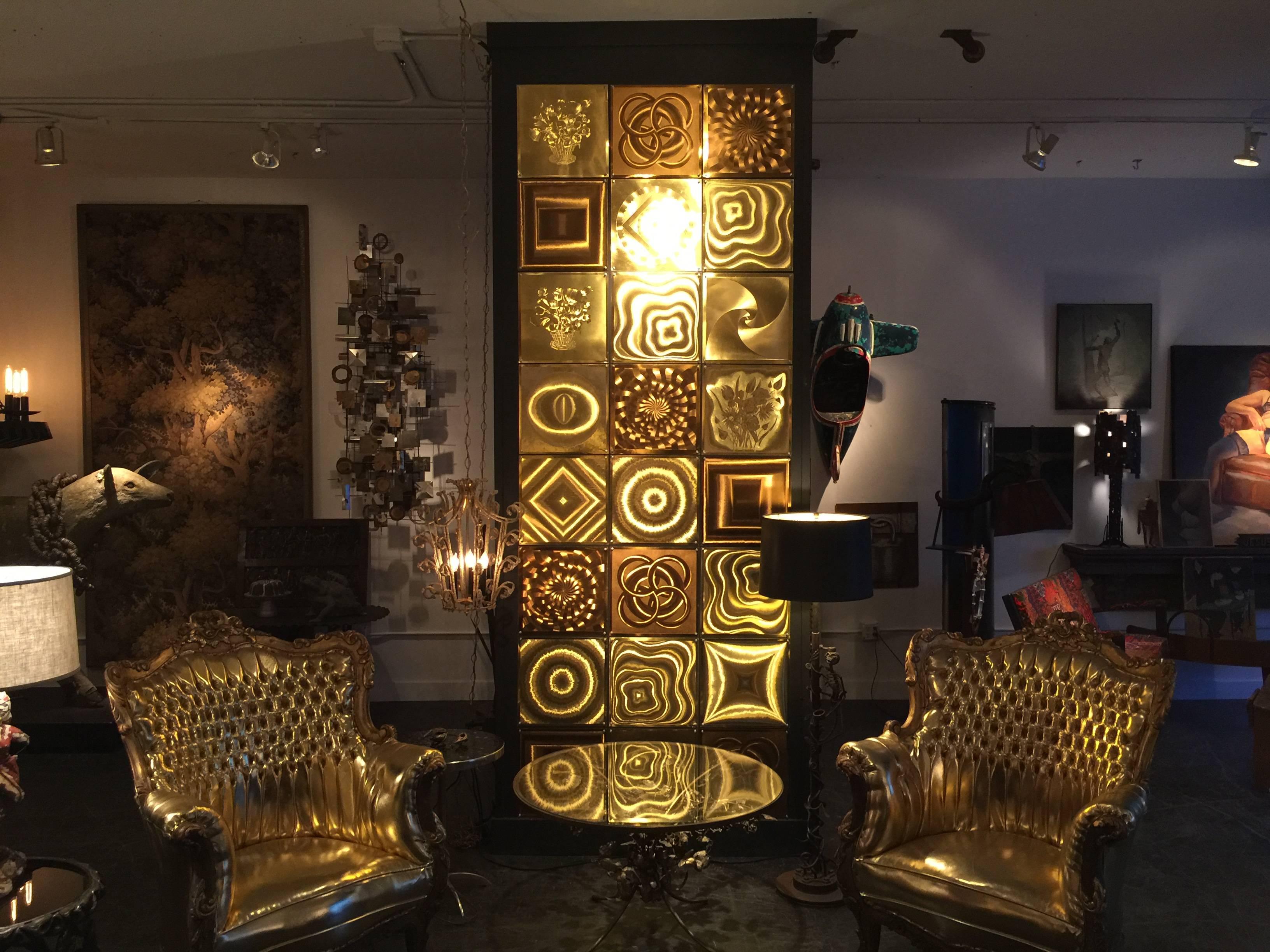 Collection of 33 highly reflective embossed 1960s cardboard hologram style panels in brass and bronze tones. Each square is displayed with four cast aluminum push pins. These can be displayed in any style fashion you'd like. Only 24 of the 33 are