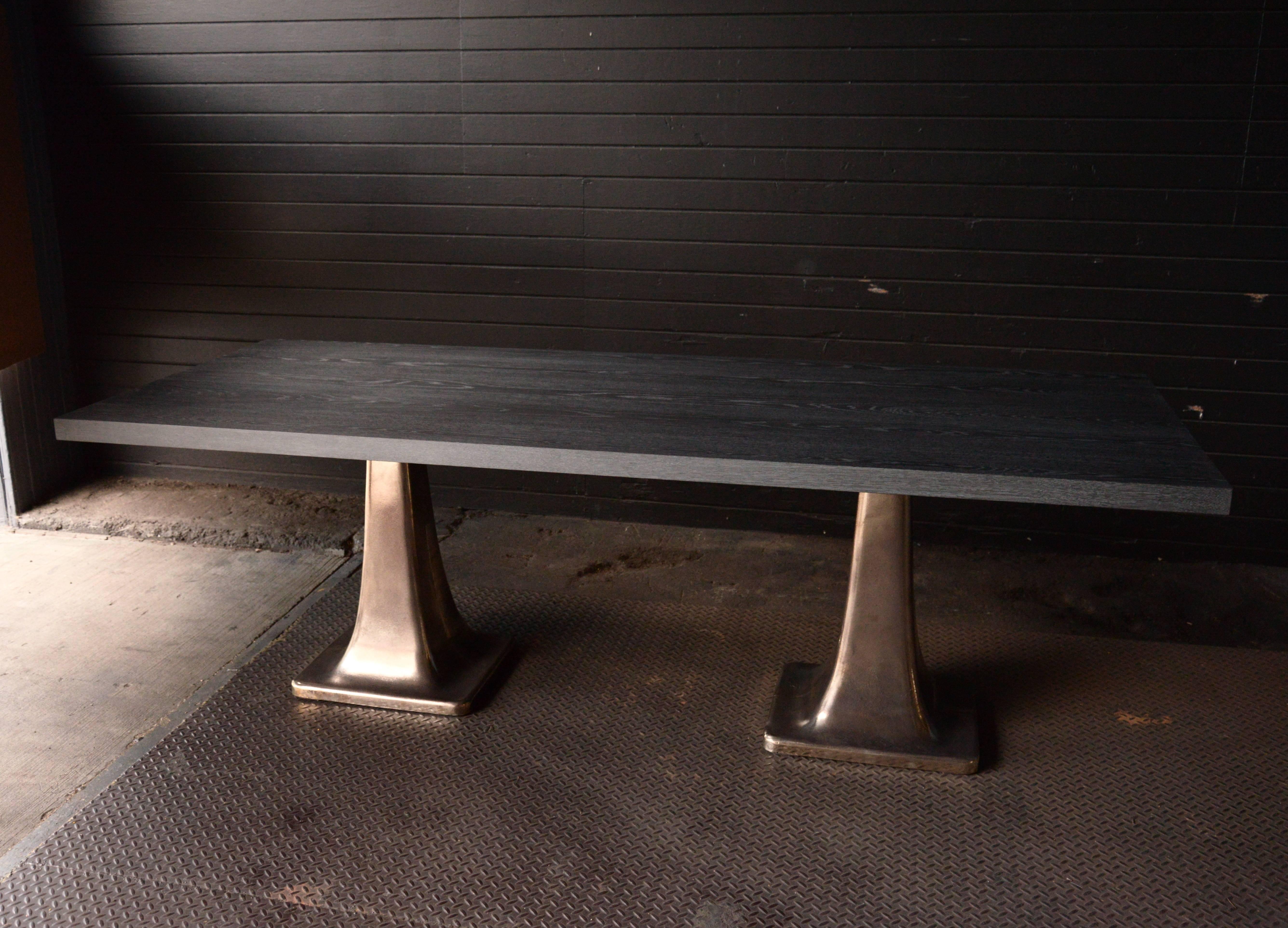 Rectangular cerused gray oak top dining table with two cast bronze pedestal bases patterned from a turn of the century machine shop lathe stand.  Custom sizes welcomed. 

   
