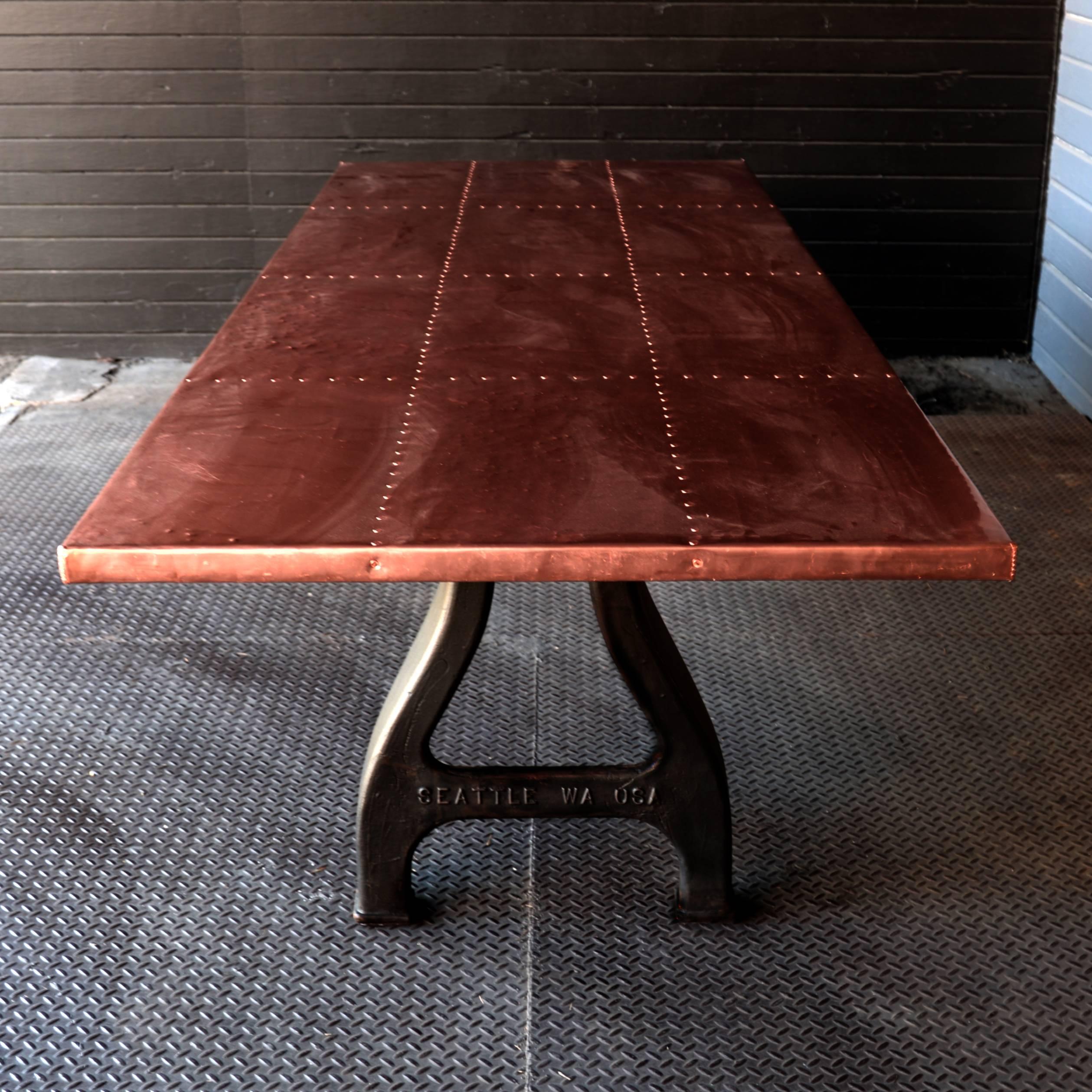 Dining tabletop clad in heavy-gauge seamless copper sheet accented with copper nailhead trim. Vintage inspired foundry leg base. Custom sizes available.
    