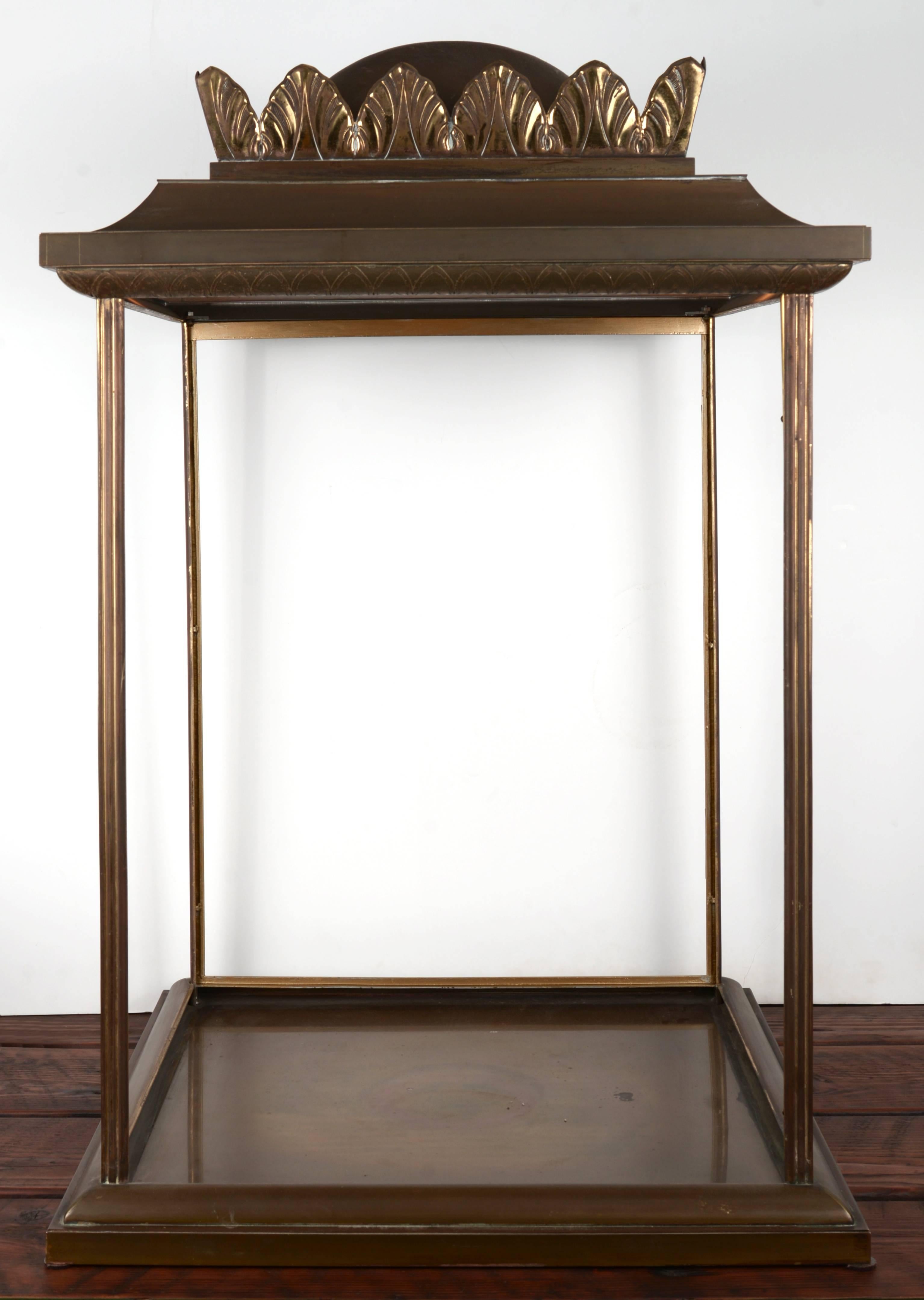 Large-scale open-style illuminated brass vitrine with a dome top and acanthus leaves detailing.