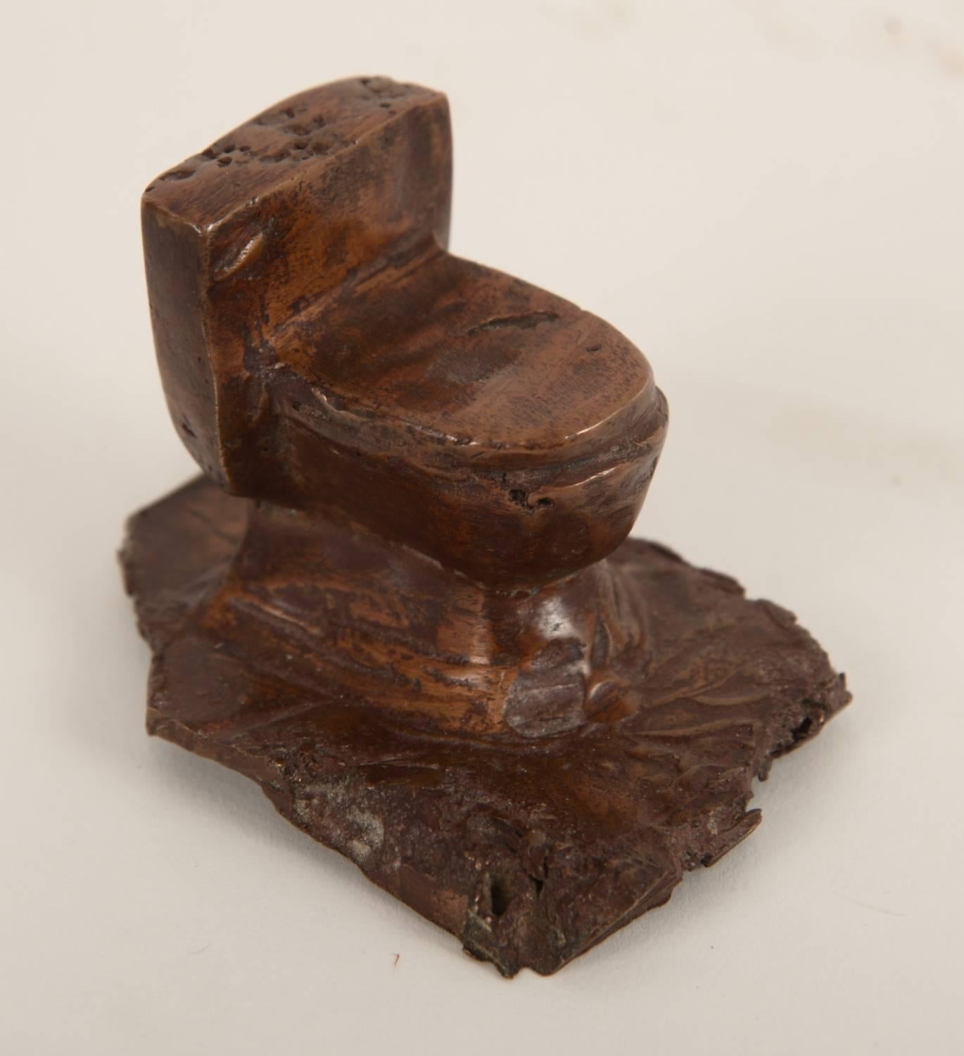Solid miniature cast bronze toilet.