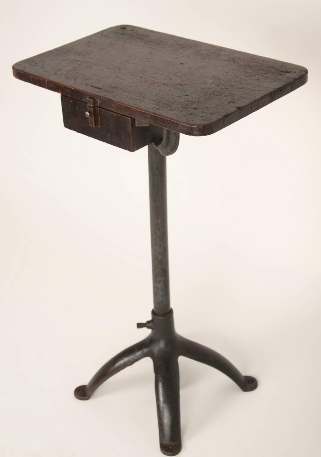 Unique small-scale pine top single drawer standing work table with cast iron base. 

         