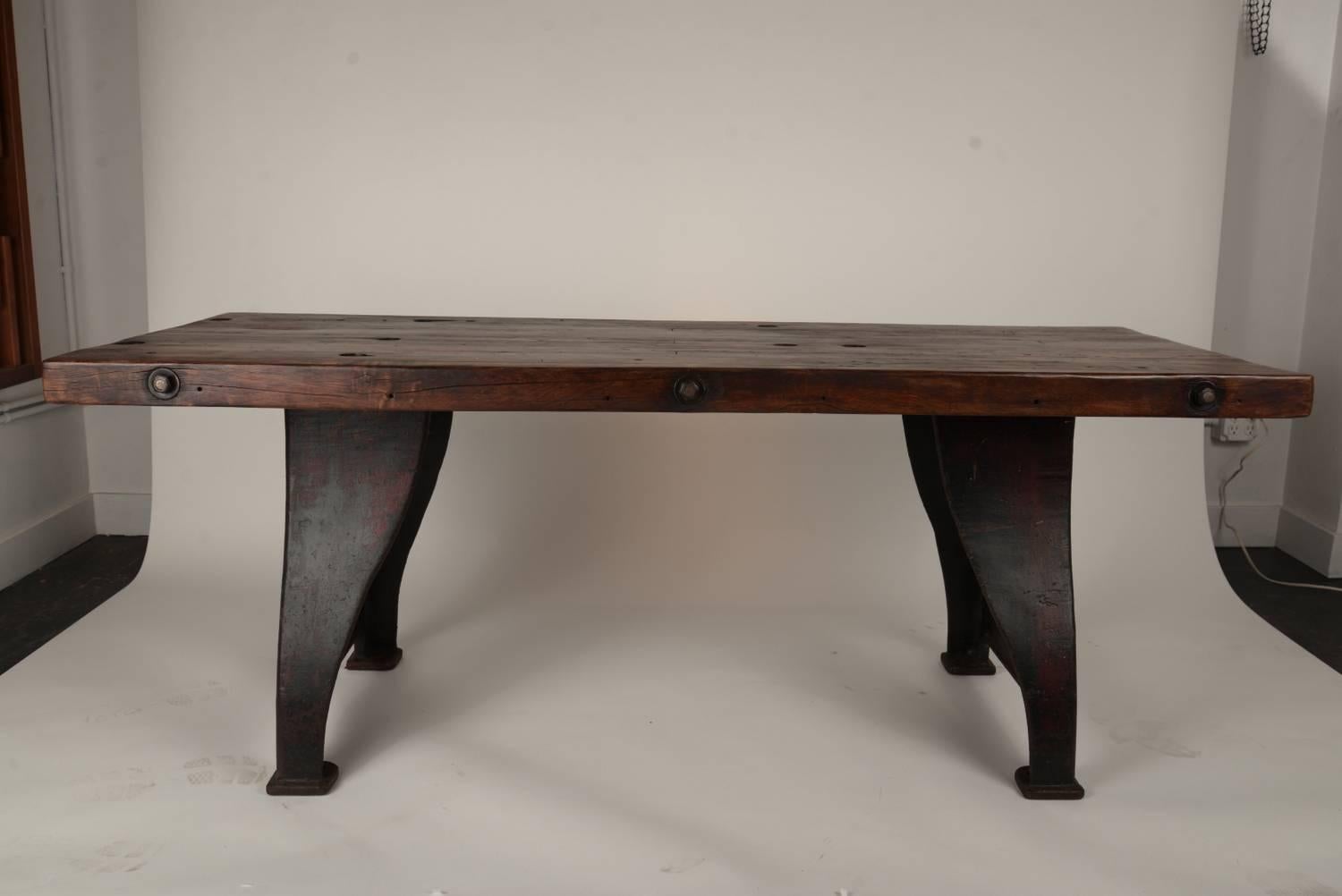 Thick Douglas-fir through bolted wooden top on vintage cast iron. A frame style legs with remnants of original red paint. This piece is super clean and is ready for heavy duty use.