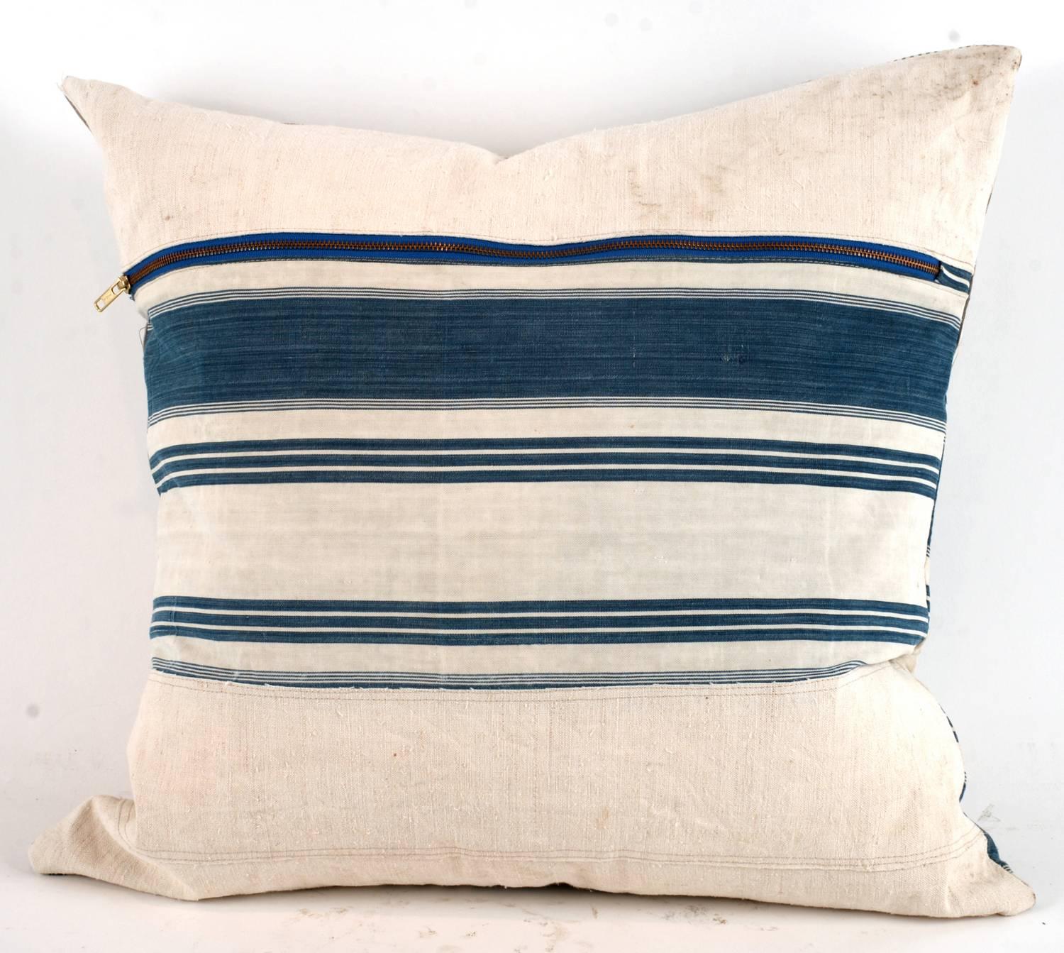 One of a king large-scale pillow constructed out of vintage textiles including canvas, drop cloth and sailcloth. All materials have been thoroughly laundered and are machine washable down inserts give these a wonderful plush relaxed feel and