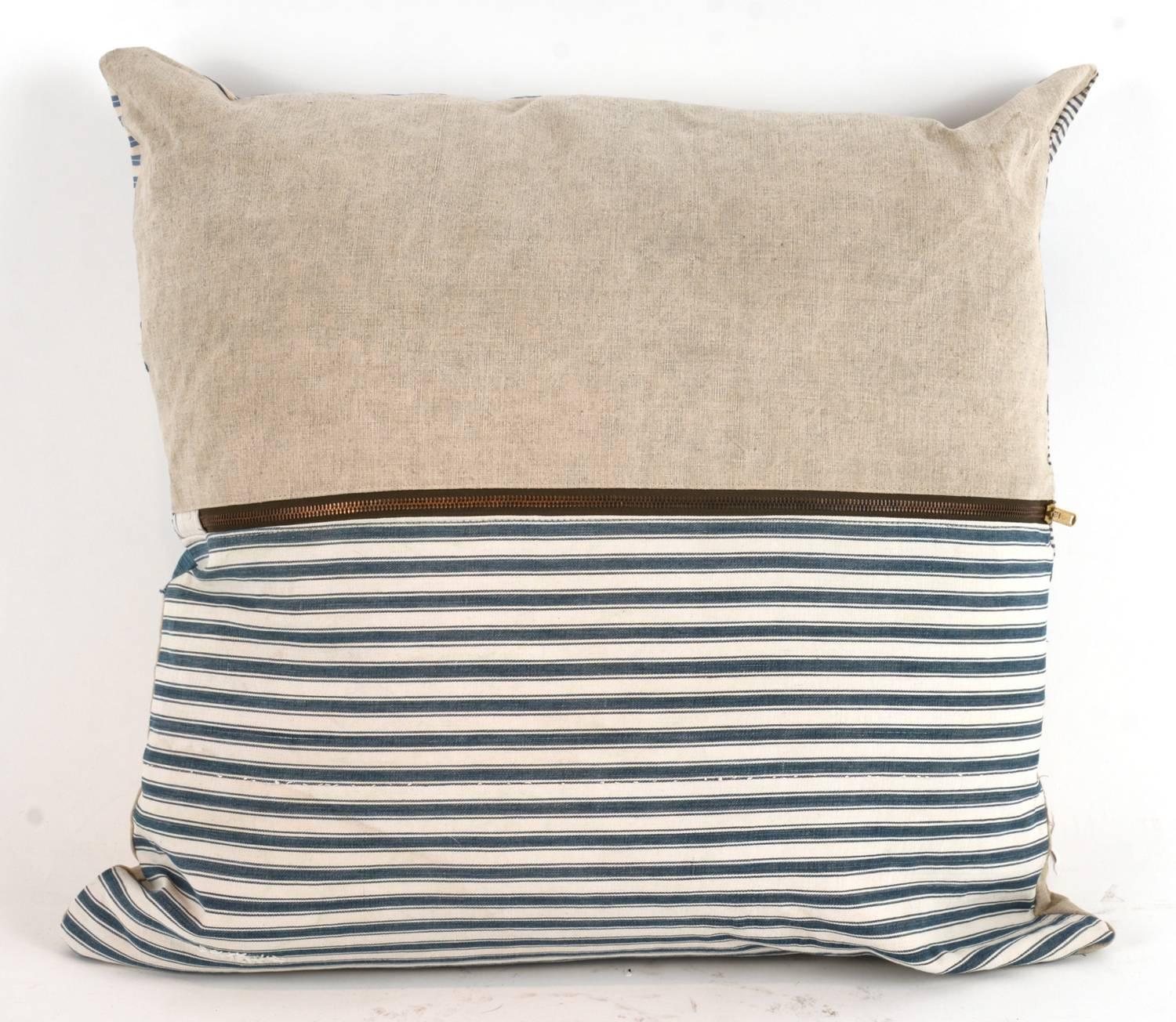 One of a king large-scale pillow constructed out of vintage textiles including canvas, drop cloth and sailcloth. All materials have been thoroughly laundered and are machine washable down inserts give these a wonderful plush relaxed feel and