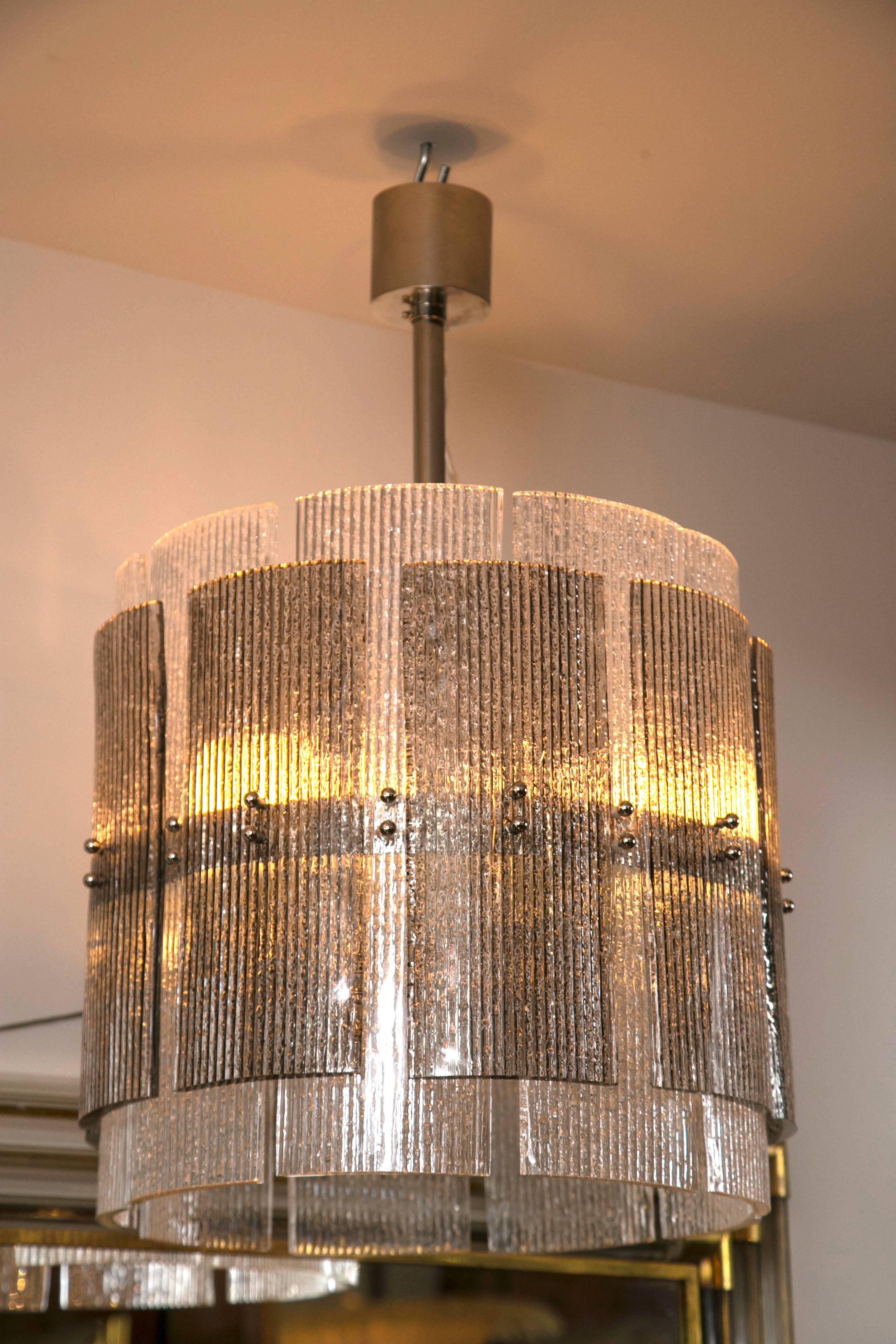 Shimmery icy and grey layered ribbed Murano glass cylindrical chandelier with matte nickel hardware, stem can be made to any desired drop. 
The height of the glass is 16 inches
sold individually
                     