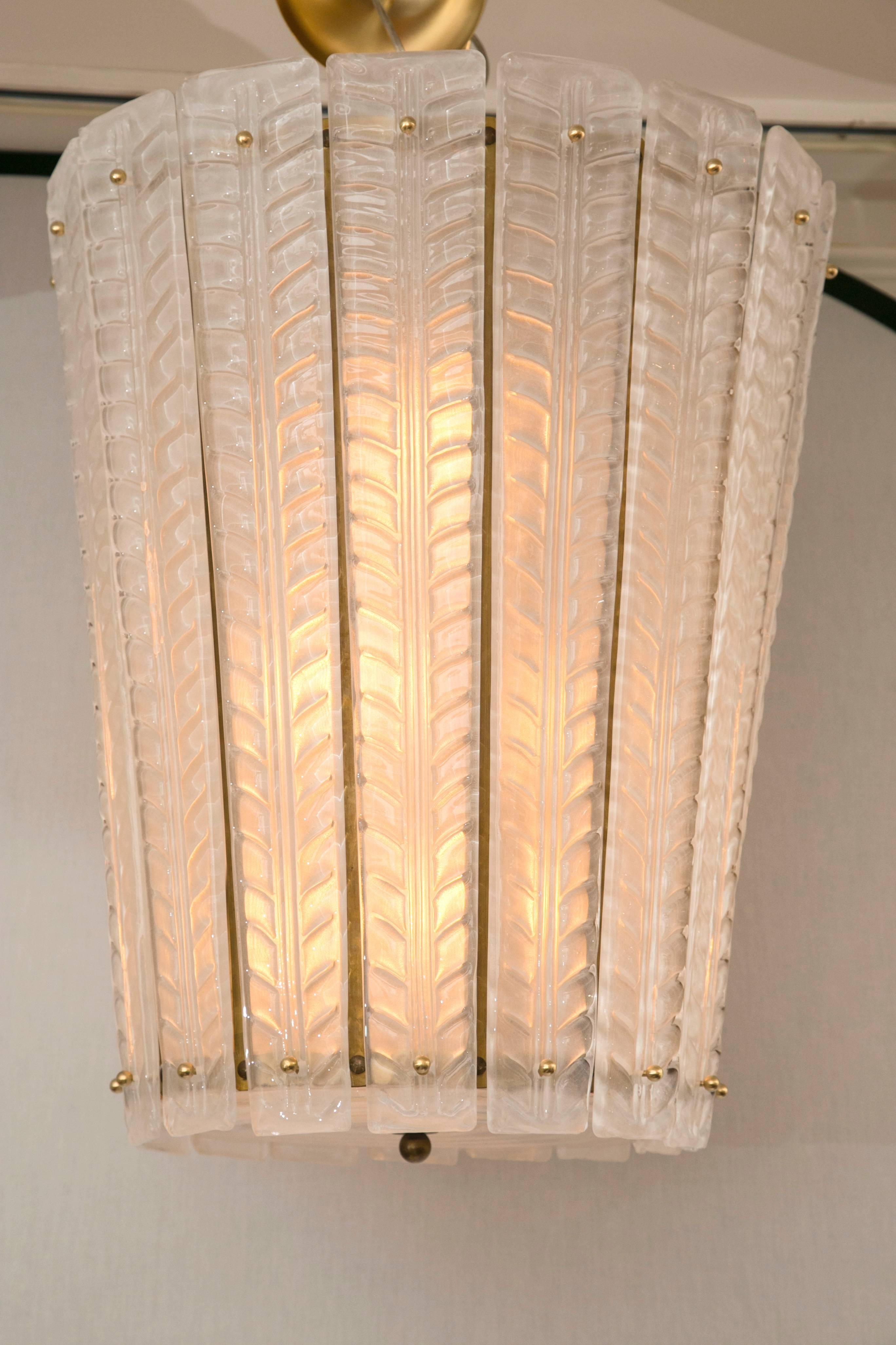 Custom blown Murano opaque white lantern comprised of 15 glass blown graduated sleeves with leaf detailing,
overall desired drop is achieved with brass chain 

Electrified to code with 6 graduated medium size sockets for even illumination
Priced