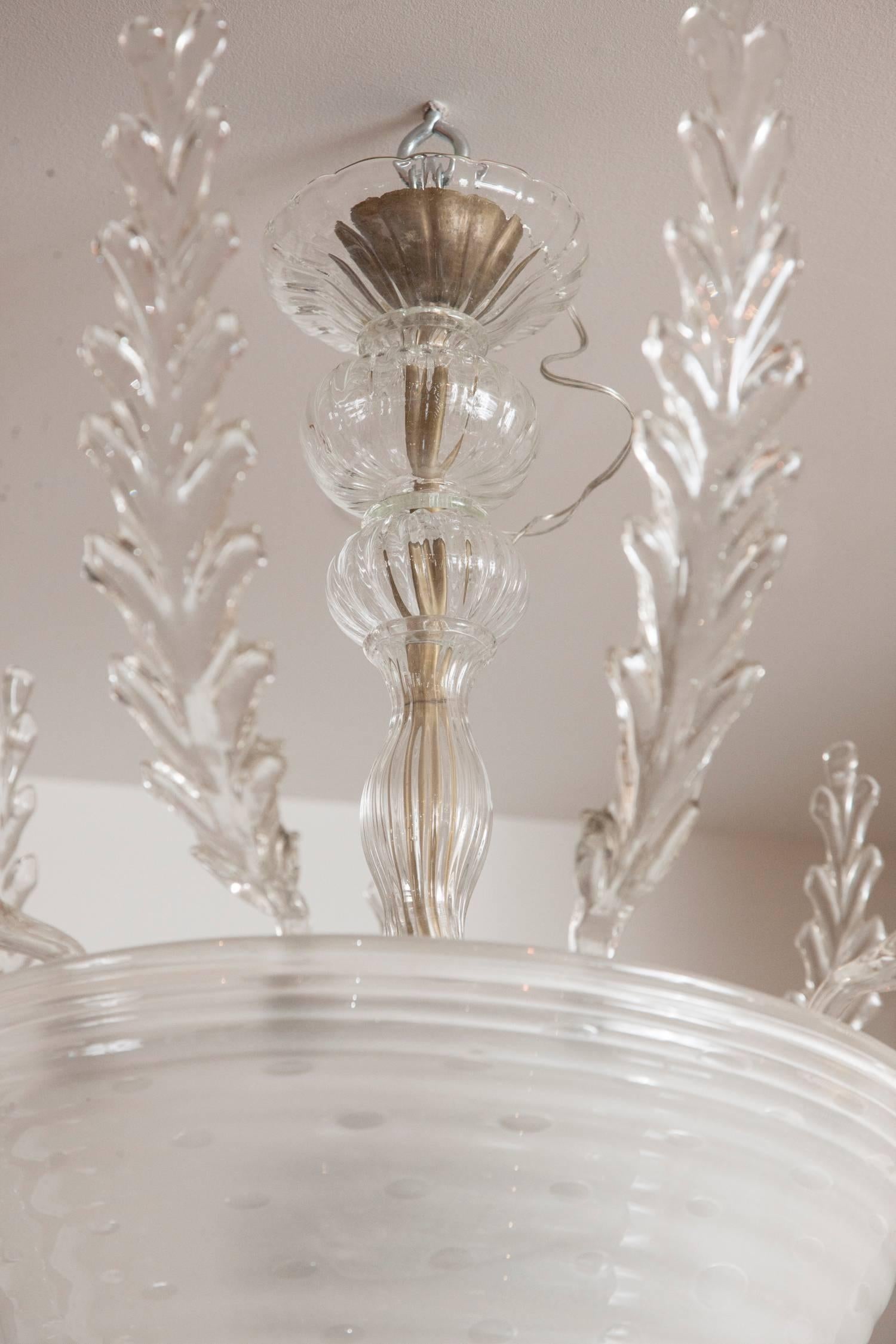 Wonderful and unique vintage ceiling light with 11 incurved clear blown feathers/leaves that sit into a deep bowl blown with white bubble and supported by a glass center stem comprised of five separate blown parts
illuminated with 3 universal
