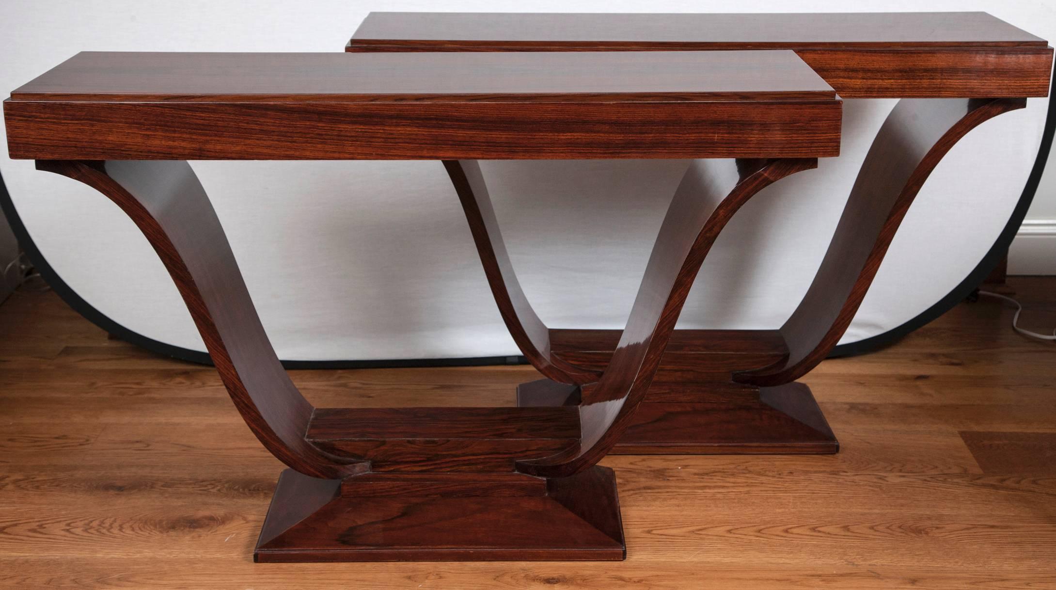 Elegant form defines these Art Deco tables with stepped rectangular shaped plateau on tulip shaped bases in rosewood veneer, recently refurbished and sizes modified, circa 1920.