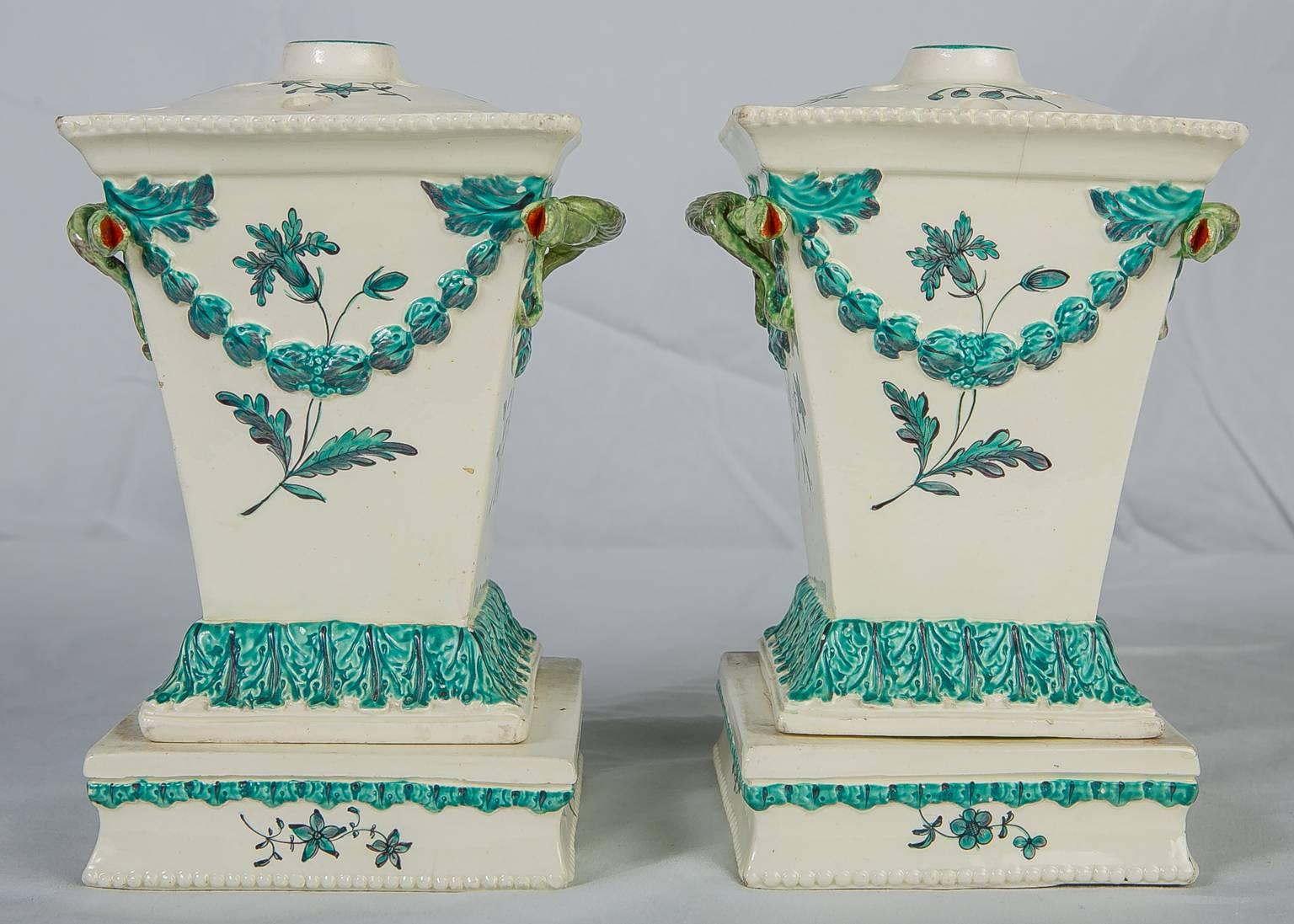WHY WE LOVE IT: One of our absolute favorites!
A pair of 18th-century creamware flower holders complete with stands and covers made in England by Neale & Co. was one of the finest 18th century English potteries. The entire composition is classically
