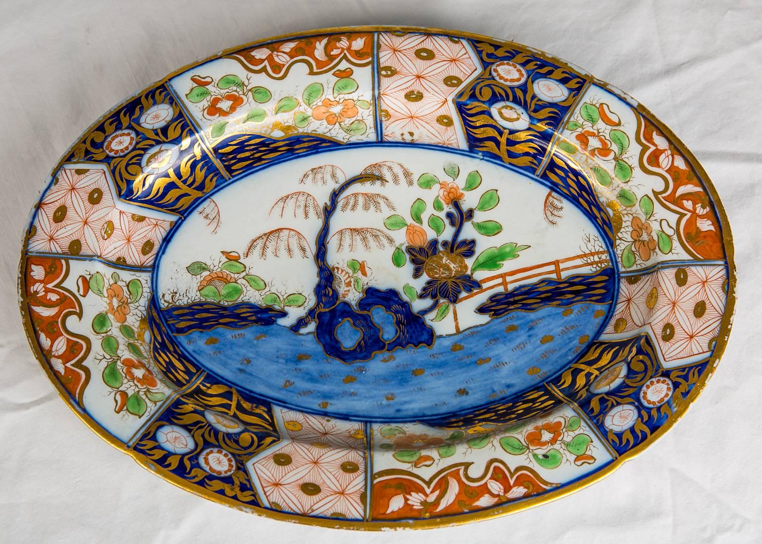 A Spode soup tureen made in England in the early 19th century.
This popular pattern features a vibrant hand-painted scene showing a fenced garden with peonies and a willow tree with golden branches. The pattern is known by several names; Rock and